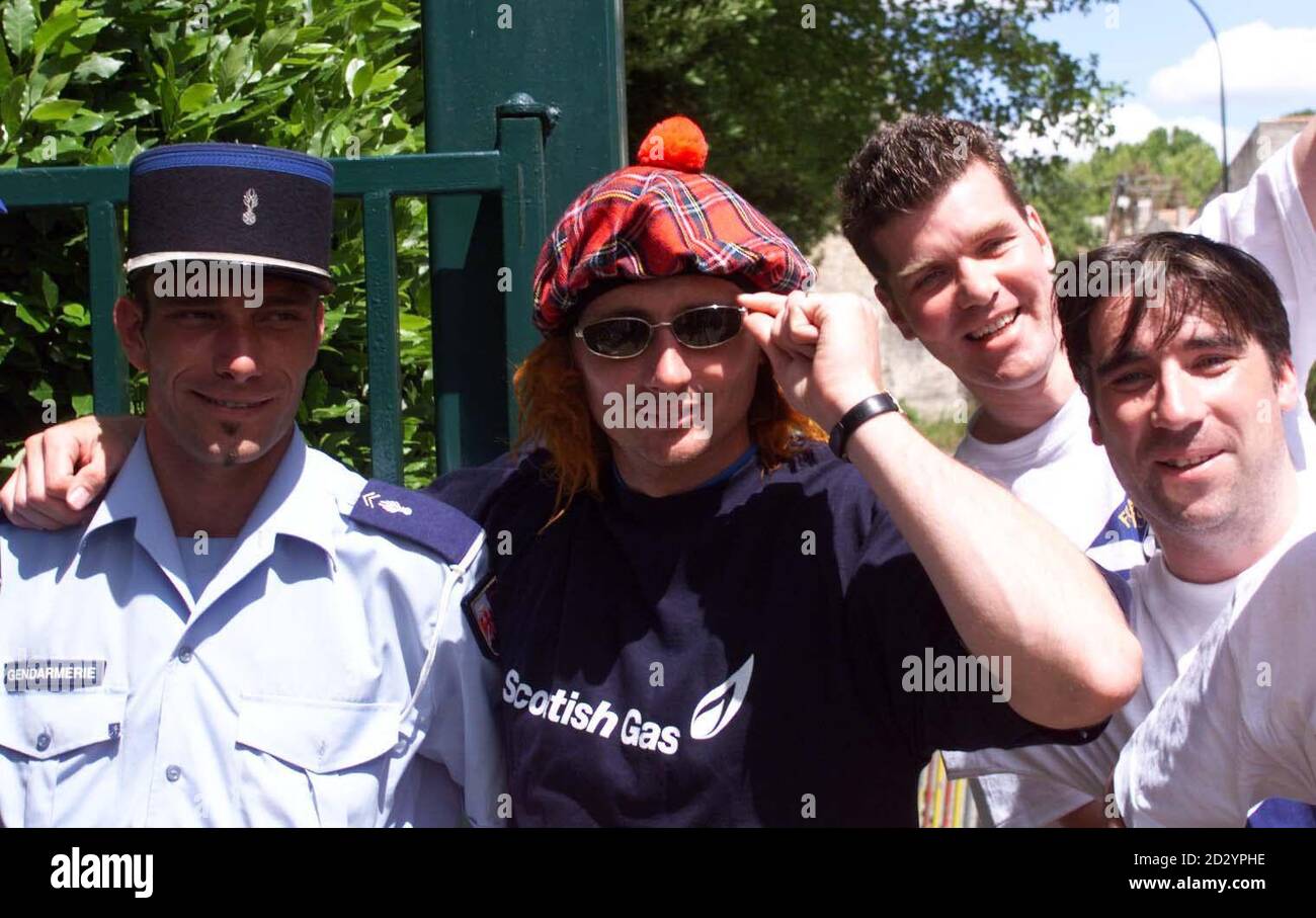 Scotland's Tom Boyd in light-hearted mood sports a 'Jimmy Hat' as he takes some time out to meet some Scottish soccer fans and a local policeman in St. Remy, France today (Sunday). The Scotland squad are due fly on to Bordeaux tomorrow for their second match of the World Cup against Norway on Tuesday. EDI Photo by Chris Bacon/PA Stock Photo