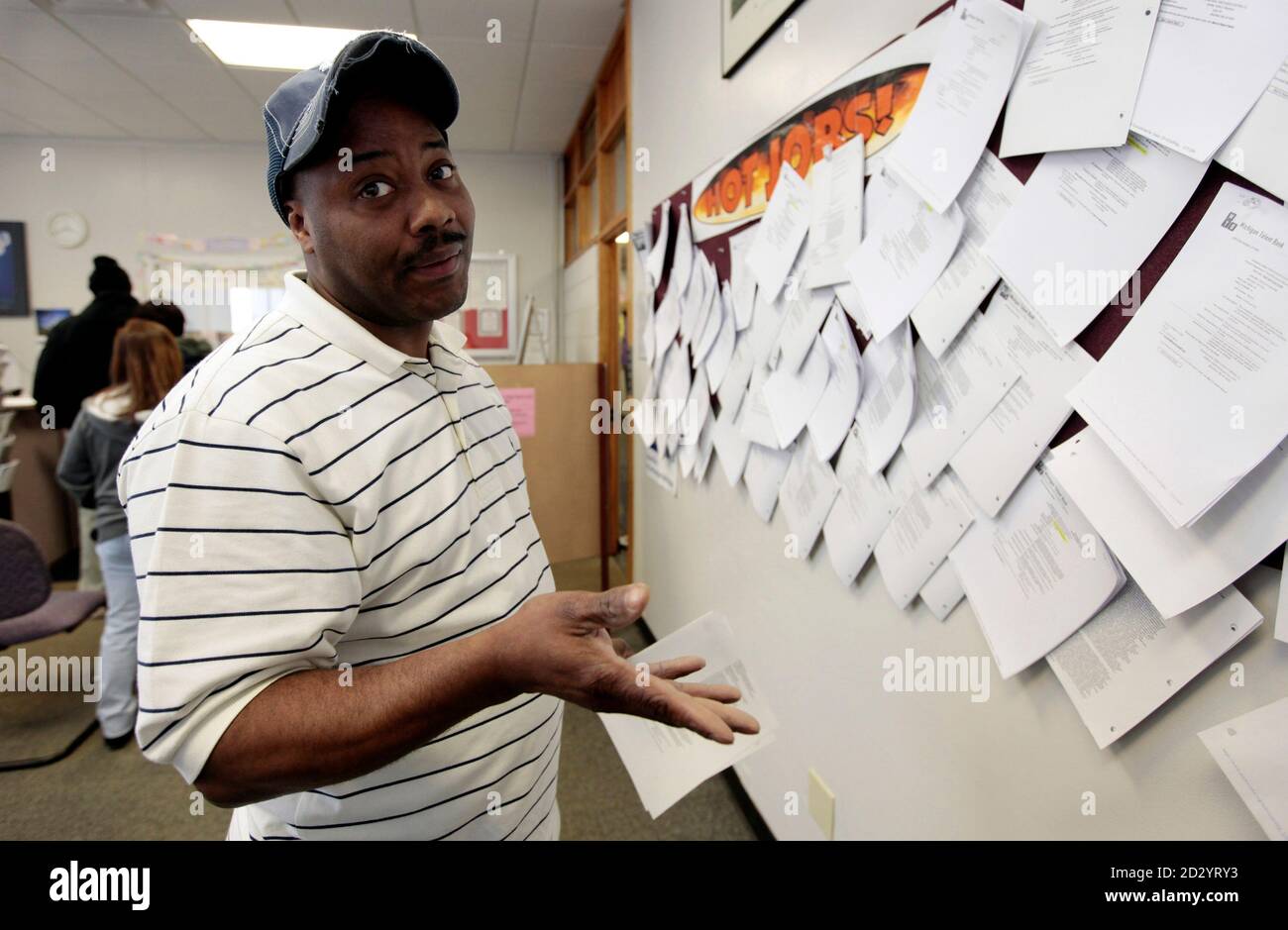 Unemployed truck driver Allen Askew III gestures to the photographer while checking job listings at a jobs search agency in Detroit, Michigan April 3, 2009. The U.S. unemployment rate soared to 8.5% last month, a 25-year high, as employers slashed 663.000 jobs and cut workers' hours to the lowest level on record, the government said on Friday.  REUTERS/Rebecca Cook  (UNITED STATES BUSINESS) Stock Photo