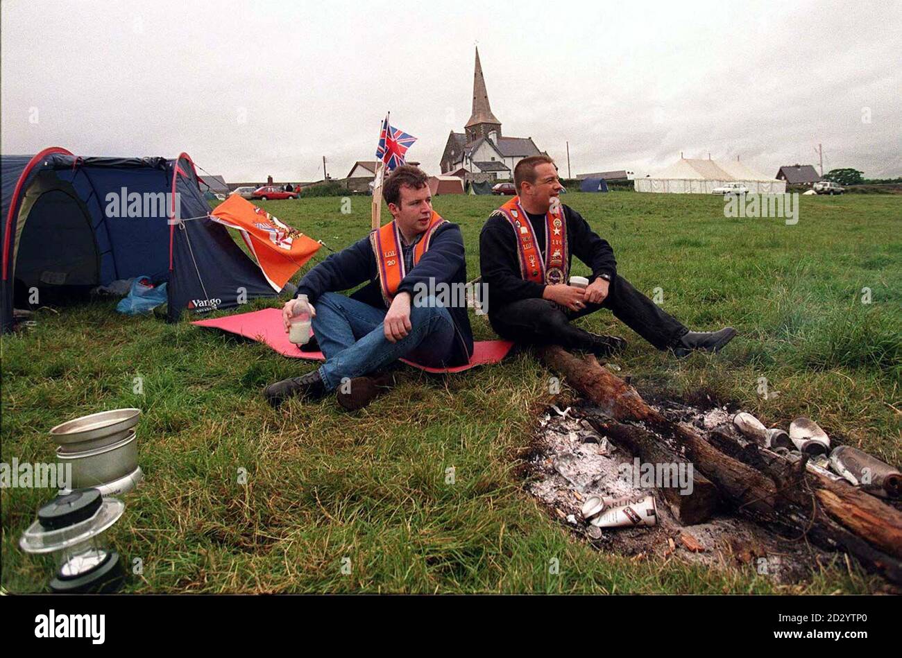 Orangemen sit around a fire in the field alongside Drumcree church today (Monday), the morning after their failed attempt to march along the Garvaghy Rd. Picture David Jones/PA Stock Photo