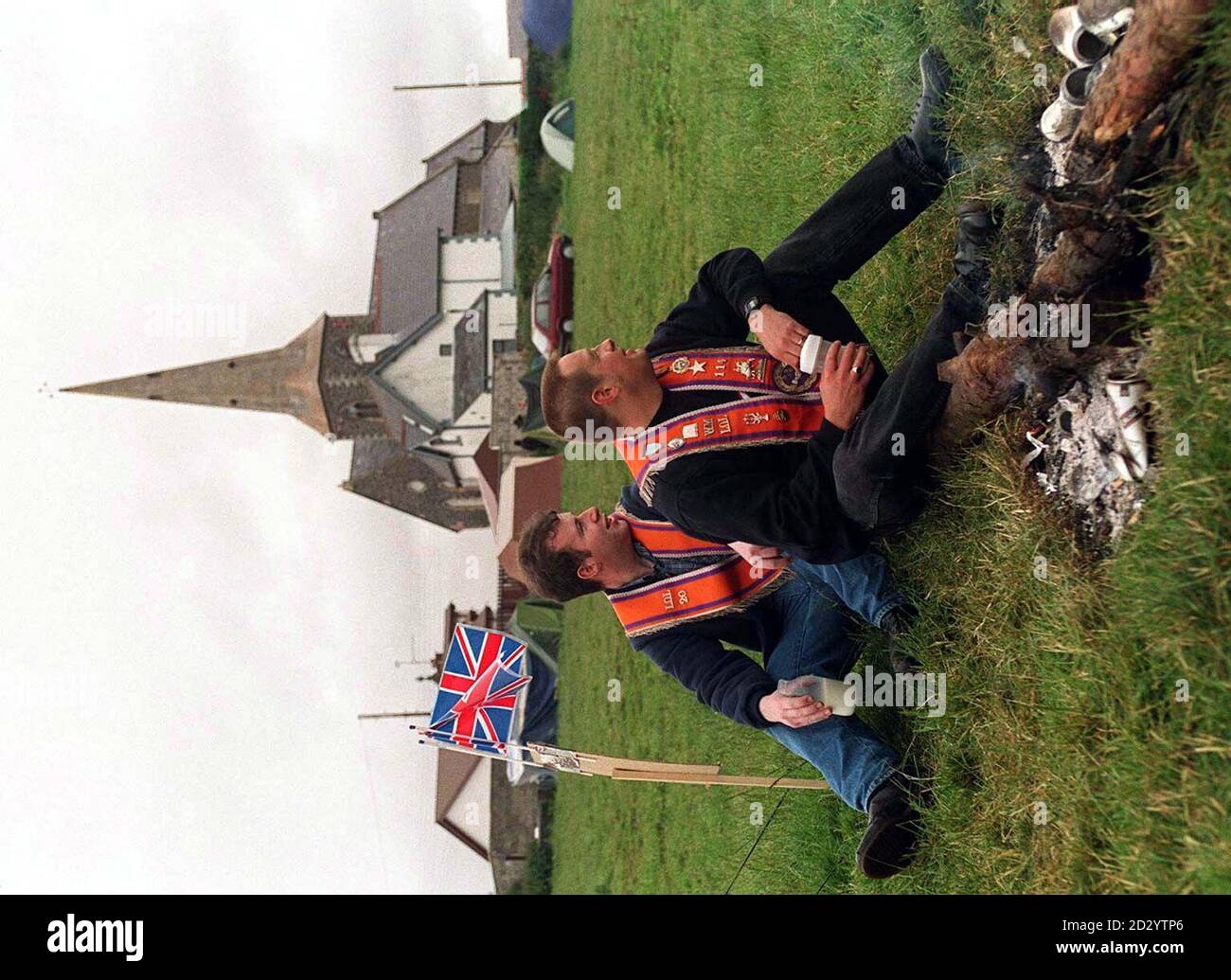 Orangemen sit around a fire in the field alongside Drumcree church today (Monday). Picture by David Jones/PA Stock Photo