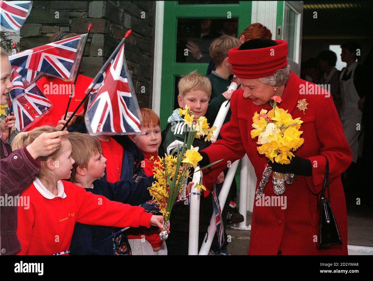 PA NEWS 20/3/98 THE QUEEN RECEIVES FLOWERS DURING A VISIT TO KESWICK SCHOOL IN CUMBRIA. Stock Photo