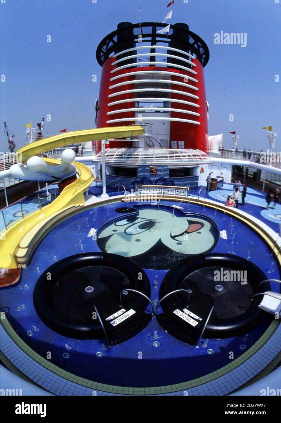 One of the main pool decks on the new Disney cruise ship, the Disney Magic, which can accommodate 2,400 guests on its eleven passenger decks. The ship is a new direction for the company, better known for its entertainment and theme parks. The seven-day holiday packages combine a three or four day trip to Walt Disney World in Florida with a three or four day cruise in the Bahamas. The 83,000-ton vessel, one of the biggest in the world, will sail from Port Canaveral in Florida, call at the historic Port of Nassau and spend a day at Disney's own private pleasure island in the Bahamas, Castaway Ca Stock Photo