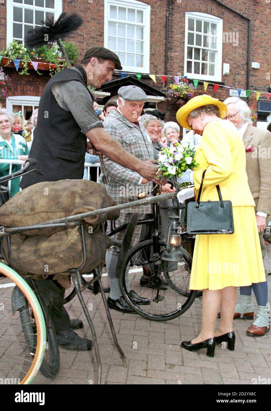 The Queen carefully checks the soot stained hand of chimney sweep Martin Cook, before agreeing to a hand shake while on a walkabout in Bridge Street, Runcorn, part of her Cheshire vist today (Friday). PA Rota picure by Dave Kendall/PA Stock Photo