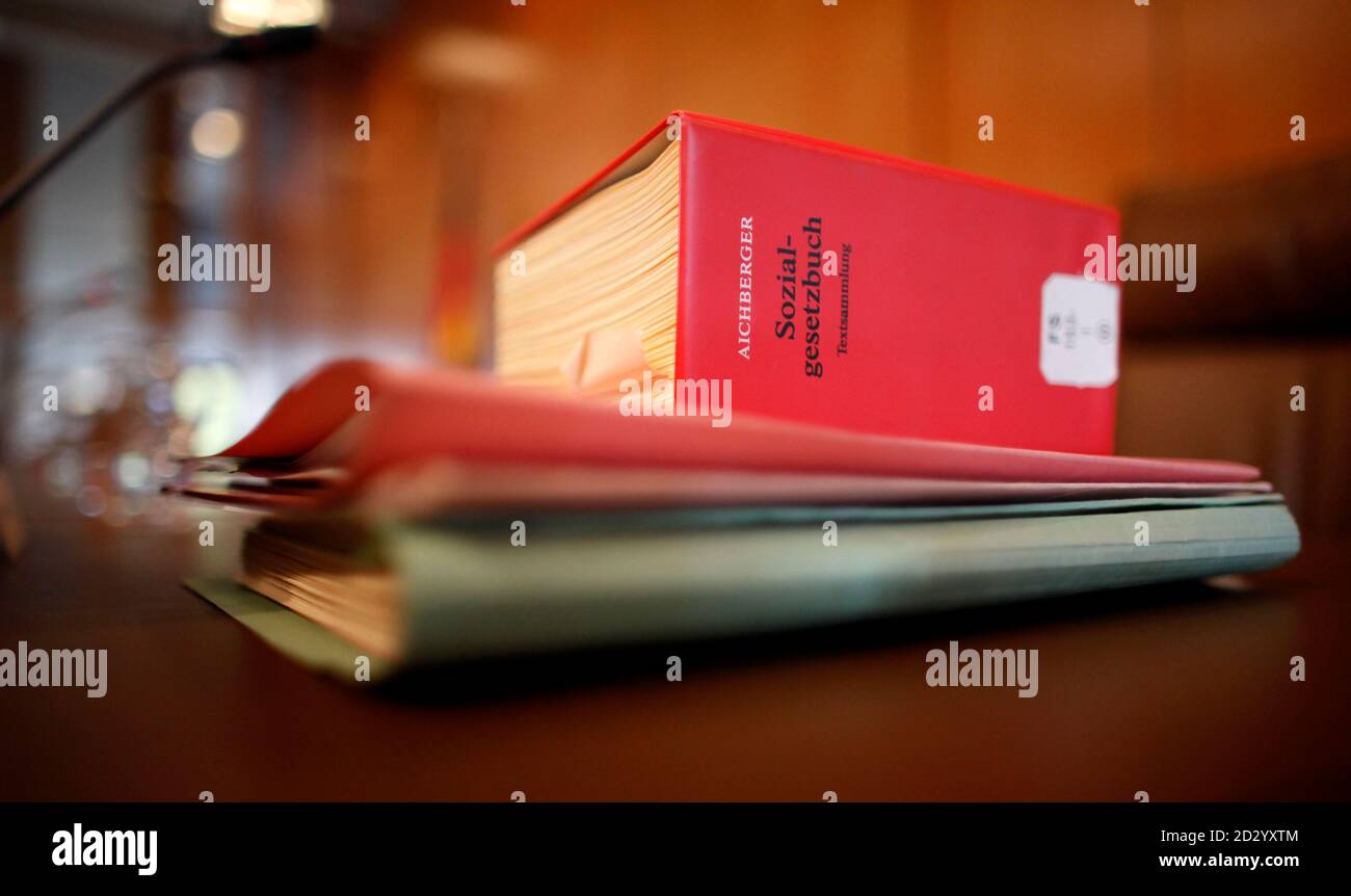 A social code book of German law (sozialgesetzbuch) and constitutional court files are pictured before a hearing about child allowances included in Hartz IV national unemployment benefits, at a court in Karlsruhe October 20, 2009. REUTERS/Johannes Eisele  (GERMANY CRIME LAW POLITICS) Stock Photo