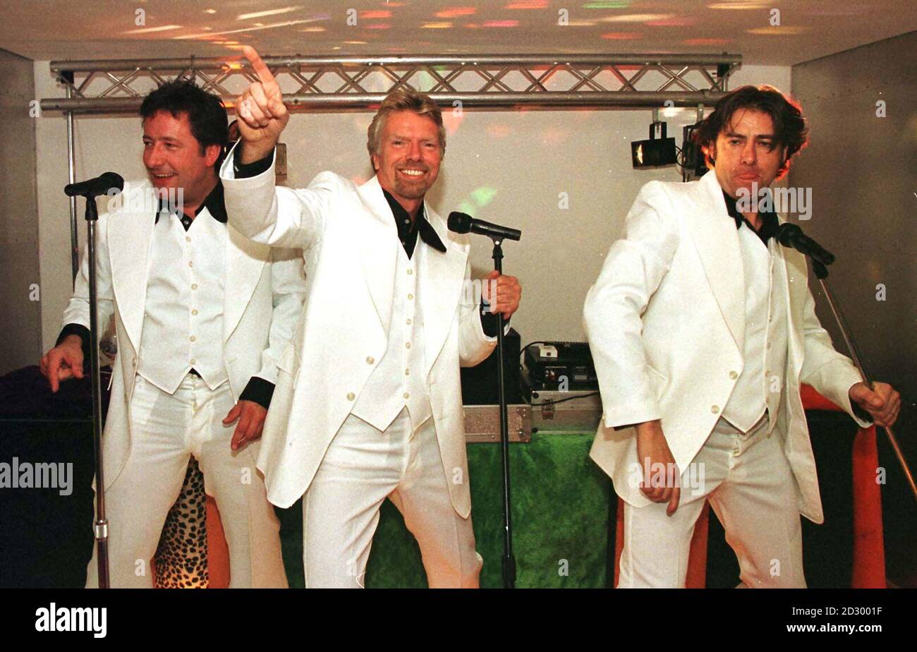 Richard Branson (centre) launched tonight (Tuesday) his new Gatwick Clubhouse with Jonathan Ross (right) and DJ Rowland Rivron in 1970's style, with a scene from Saturday Night Fever in the Disco area of the new Lounge. Photo Tim Ockenden/PA Stock Photo