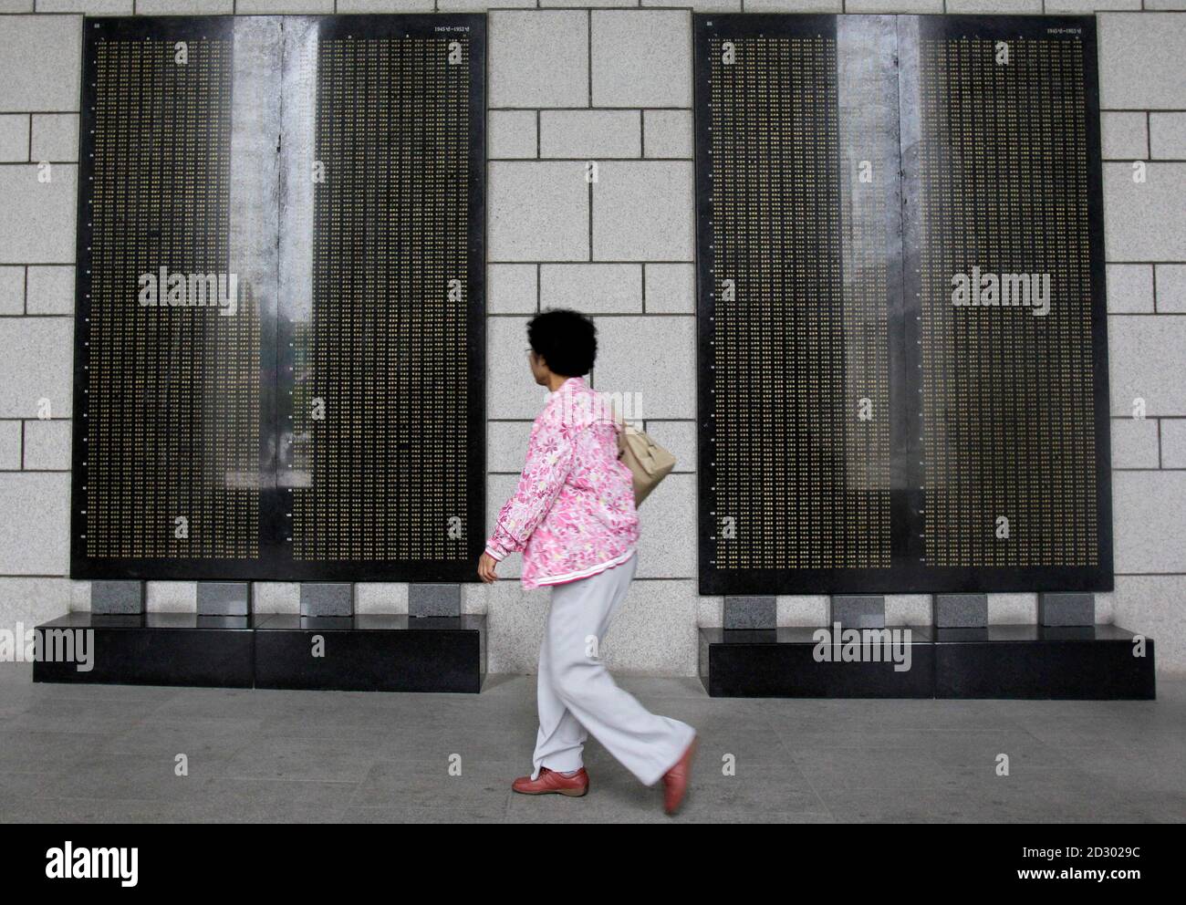 A woman walks past monuments to those killed in action during the 1950-53 Korean War at the Korean War Memorial Museum in Seoul May 23, 2010. The United Nations Command (UNC) has launched an investigation into whether North Korea violated the Korean War armistice by sinking the South's naval corvette Cheonan on March 26, the U.N. body said on Saturday. North Korea denounced the probe as a 'bogus mechanism.'  REUTERS/Jo Yong-Hak (SOUTH KOREA - Tags: POLITICS MILITARY) Stock Photo