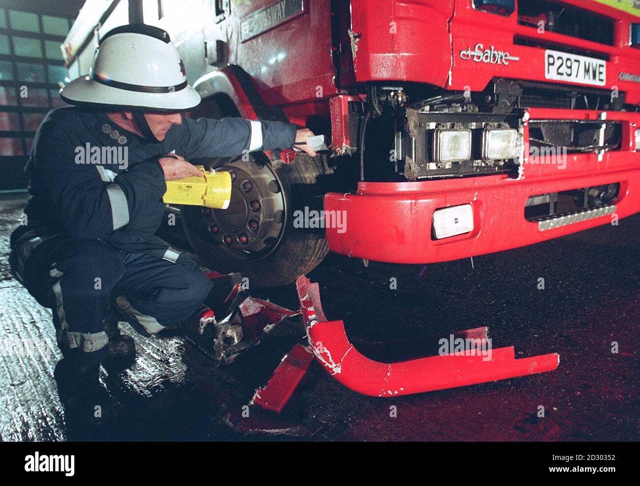A fire officer examines the damage caused to a fire-engine after a ...