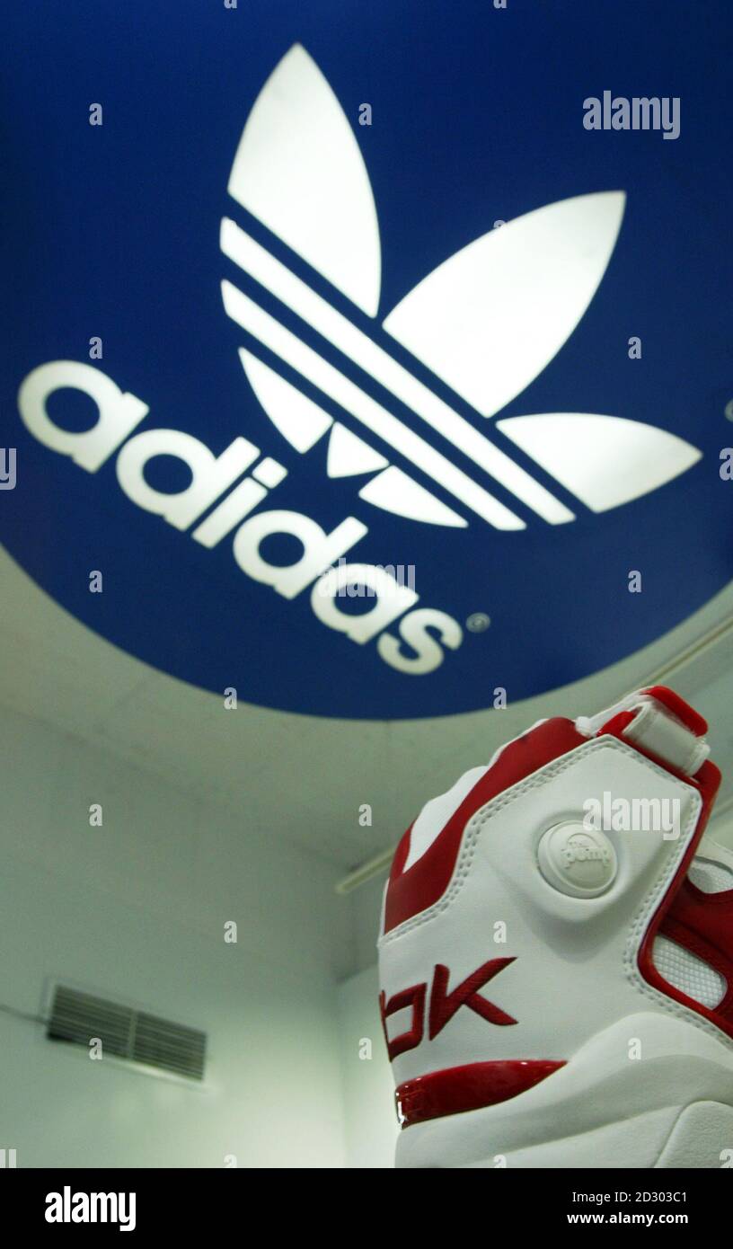 A Reebok shoe is displayed in a shop under a giant Adidas logo in Taipei  August 4, 2005. Adidas-Salomon plans to buy Reebok for 3.1 billion euros  ($3.8 billion), merging the top
