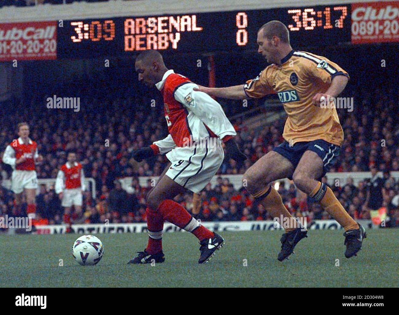 Arsenal's Nicolas Anelka evades a tackle from West Ham United's