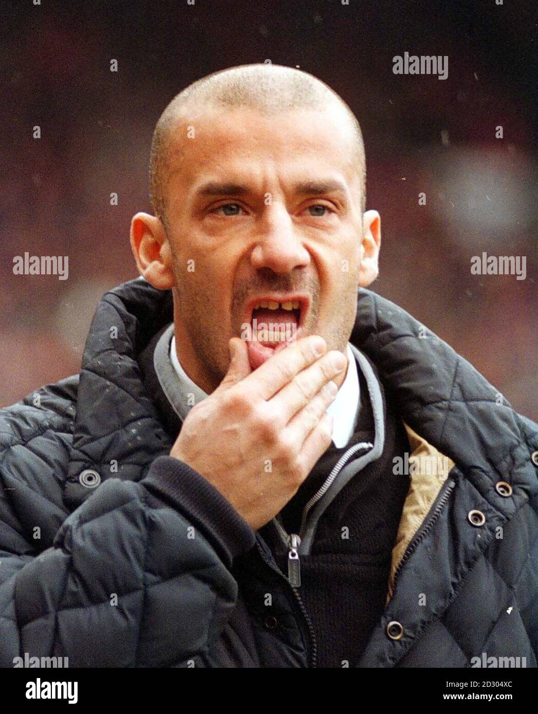 This picture can only be used within the context of an editorial feature. Chelsea manager Gianluca Vialli deep in thought, during his sides 0-0 draw, against Manchester United, in the FA Cup Quarter Final clash at Old Trafford.*12/09/2000 Vialli is sacked as manager by Chelsea, according to Sky Sports.com.  19/04/04: Gianluca Vialli who has fired a broadside at the man who dismissed him - former Chelsea chairman Ken Bates. The former Italy striker was fired in September 2000 in spite of winning three trophies for the club. Stock Photo