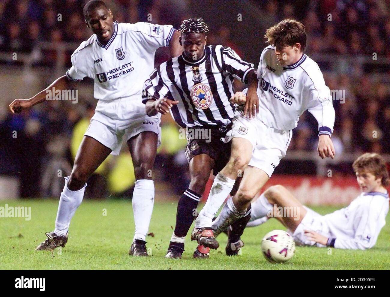 This picture can only be used within the context of an editorial feature. Newcastle's Louis Saha is sandwiched between Tottenham Hotspur's Sol Campbell (left) and Darren Anderton during their FA Carling Premiership match at St James Park.  Stock Photo