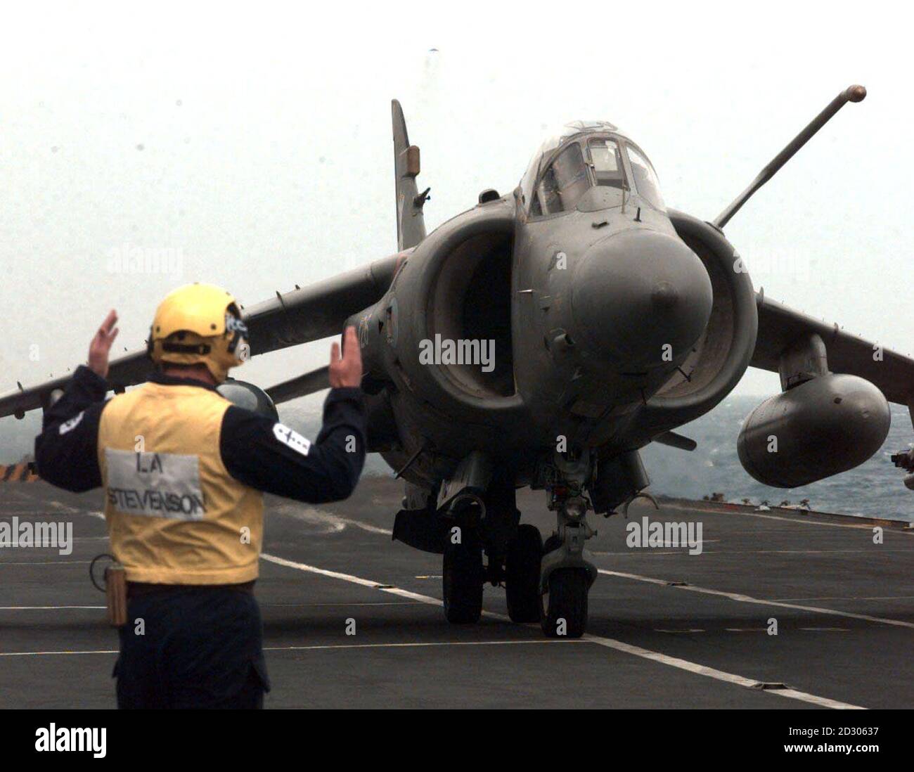 FA2 Sea Harrier landing on the deck of HMS Invincible aircraft carrier as it joins the NATO forces off the Balkan coast. The aircraft will boost the British contribution to airstrikes against Serbian military targets.   Stock Photo