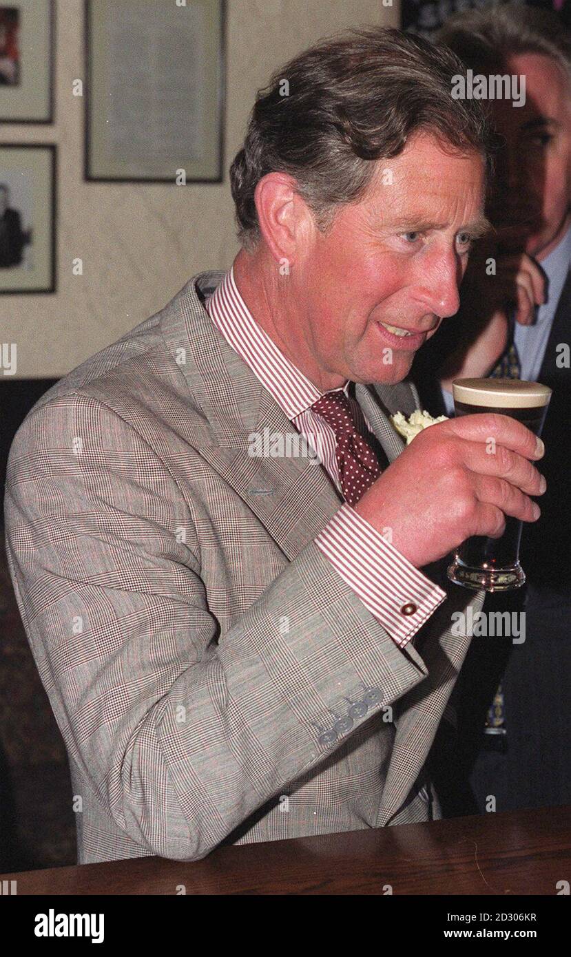 The Prince of Wales enjoys a half pint of Guinness in The Thatch Inn, Broughshane, during his visit to the village, near Ballymena in Northern Ireland. The Prince has spent the day meeting meet victims and relatives of those who died in the 1998 Omagh bomb atrocity. Stock Photo