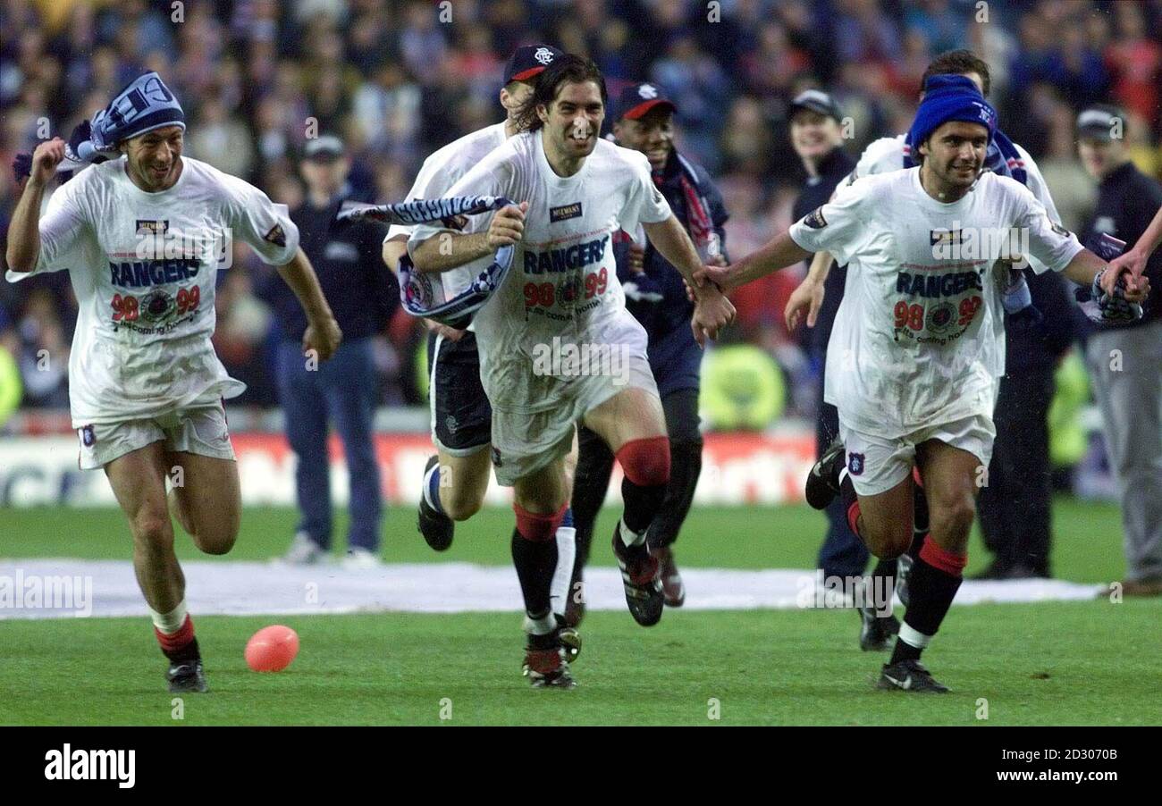 Left-right: Derek McInnes, Gabriel Amato and Luigi Riccio run a victory lap around the Ibrox Stadium in Glasgow after Rangers won the 1998/99 Scottish Premier League. Stock Photo