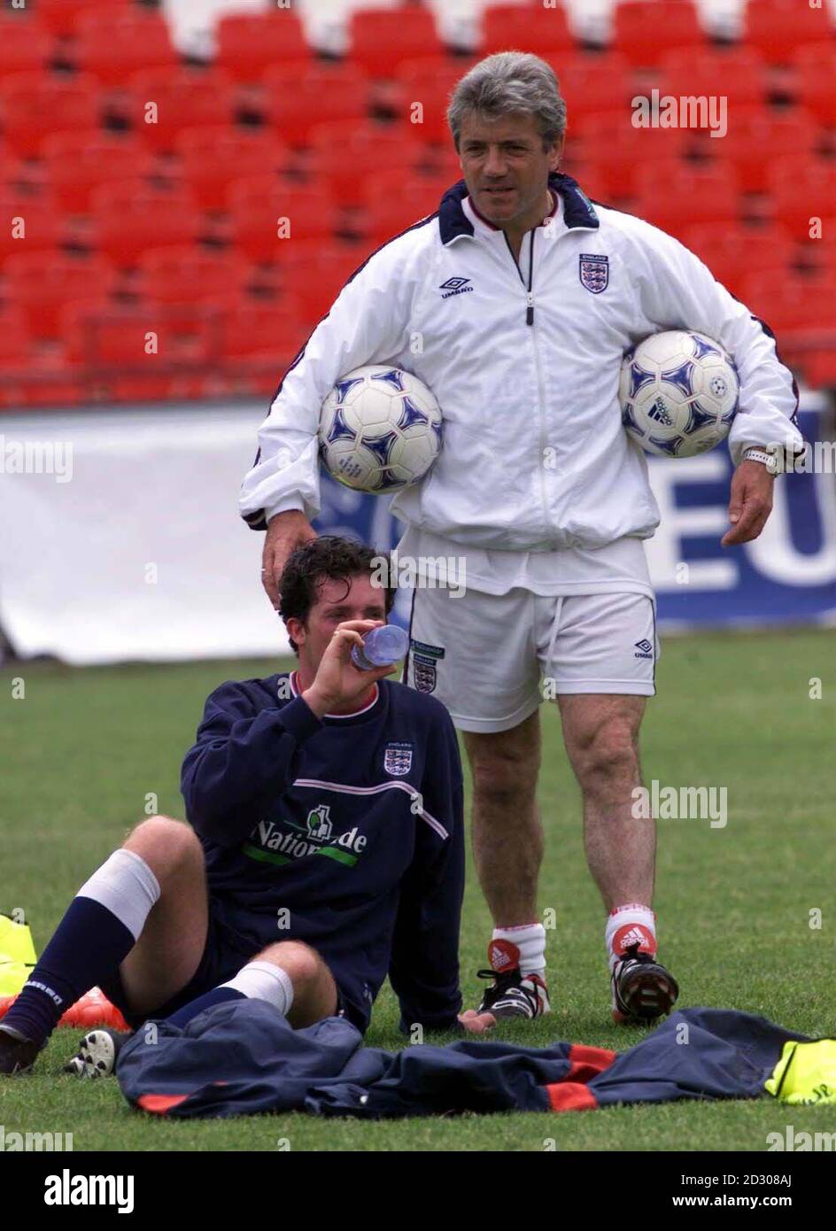 Robbie Fowler (left) takes a break from training with England coach Kevin Keegan at the Bulgarian Army stadium in Sofia, Bulgaria, ahead of England's Euro 2000 qualifying football match against Bulgaria. Stock Photo