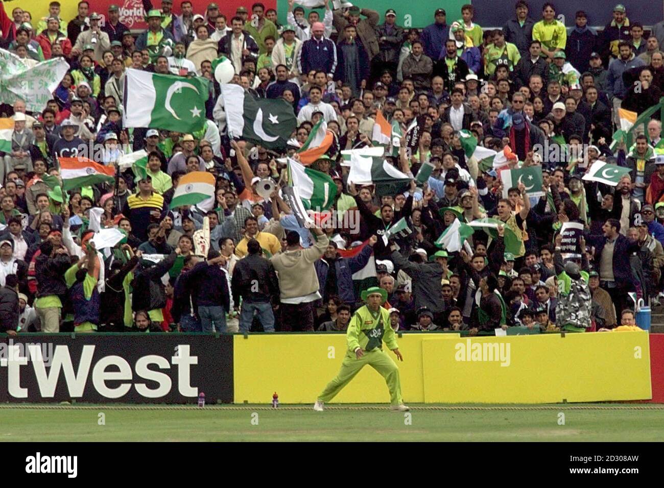 Pakistani fielder Azhar Mahmood fields in front of animated supporters during Super Six Cricket World Cup match between India and Pakistan at Old Trafford, Manchester.  Stock Photo