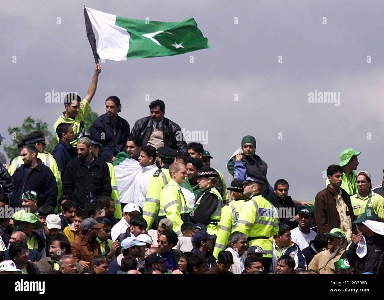 Police keep a close eye on Pakistani and India supporters during the Super Six Cricket World Cup 1999 match at Old Trafford. Stock Photo