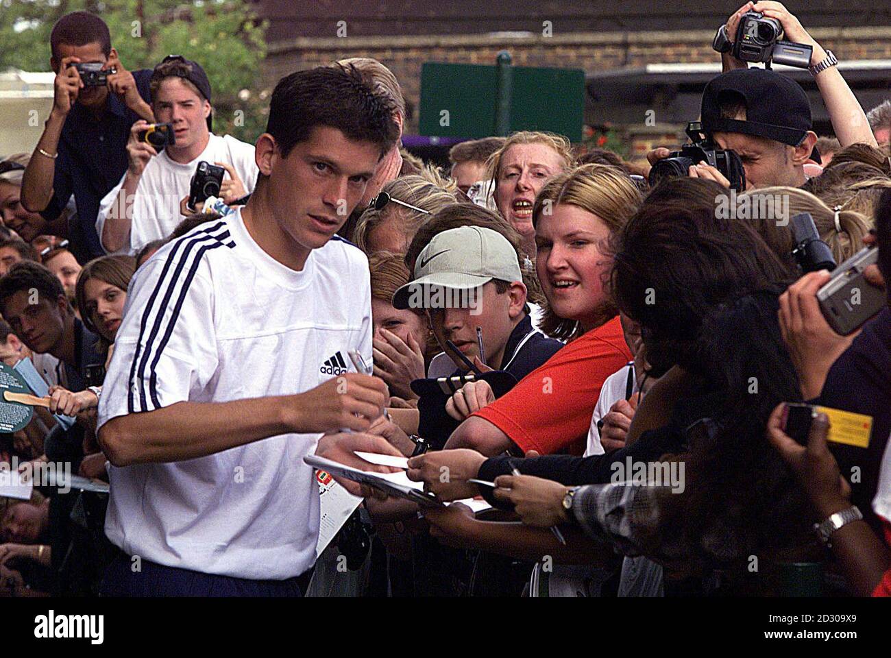 No Commercial Use. British tennis star Tim Henman signs autographs before he leaves Wimbledon after he lost his semi-final match against Pete Sampras 3-6, 6-4 , 6-3, 6-4. Stock Photo
