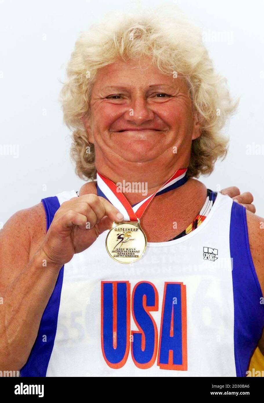 Kathleen Jager 56, USA, with her medal after winning the womans 200m  final in 28.32 seconds, a World record for her age, at the Gateshead Stadium Gateshead. She is facing allegations that she is competing in the World Veteran Games as a woman but is actually a man. Stock Photo