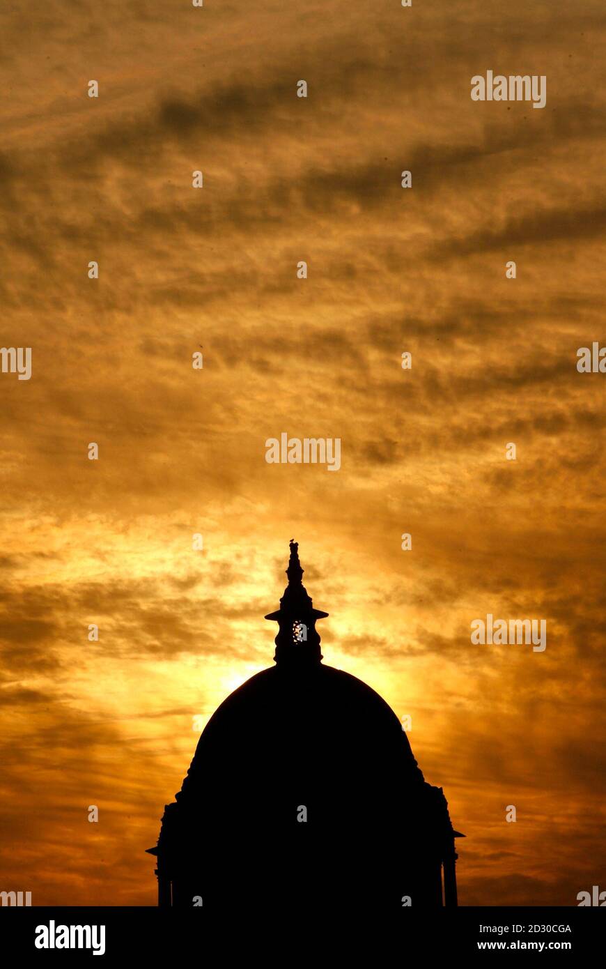 The dome of the Defence Ministry building is silhouetted against the setting sun in New Delhi December 31, 2007. REUTERS/Adnan Abidi (INDIA) Stock Photo