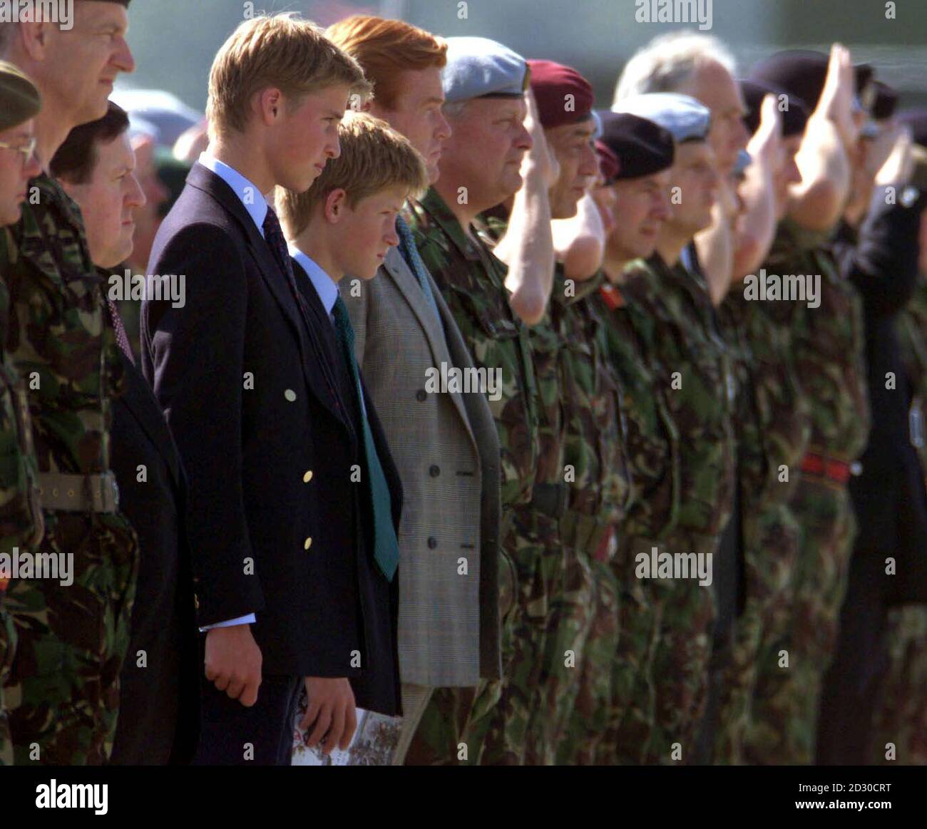 Prince William (left, gold buttons) and his brother Prince Harry (to the right of Prince William) at RAF Wattisham in Suffolk, on the day that the report into the death of their mother, Princess Diana, was published in France. Stock Photo