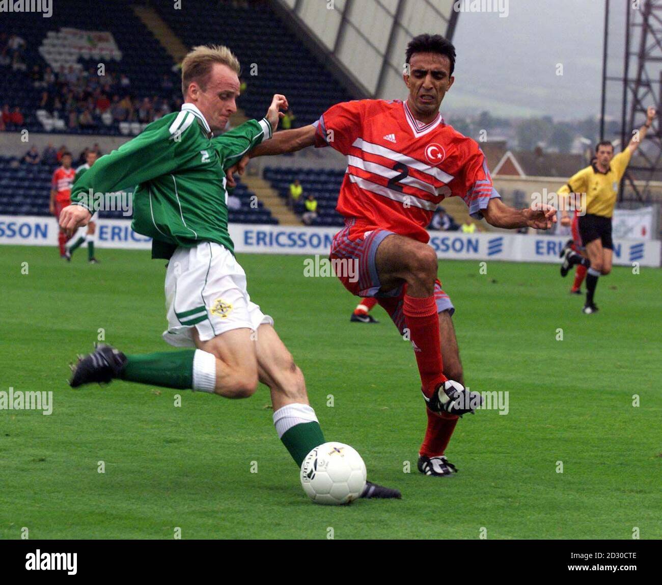 Nothern Ireland's John Mc Carthy (left) beats  Turkey's Beserler to the ball in the Euro 2000 qualifier football match at Windsor Park in Belfast. Stock Photo