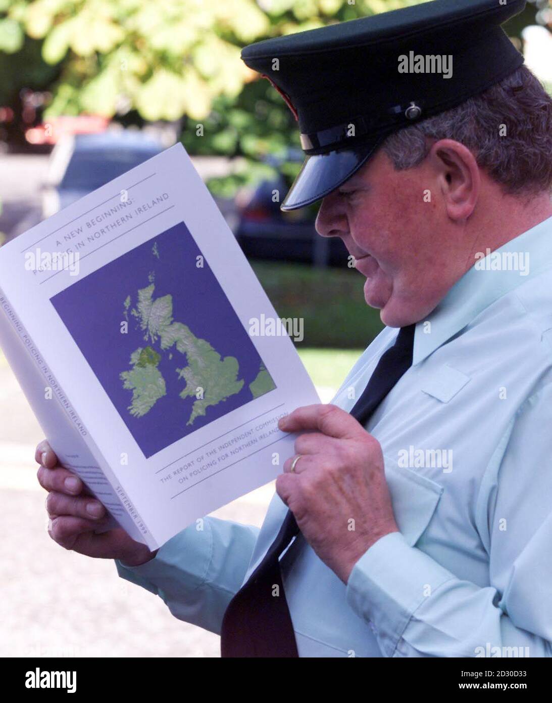 A constable from the Royal Ulster Constabulary looks over the Patten report into the reform of the RUC, at RUC headquarters, in Belfast. Stock Photo