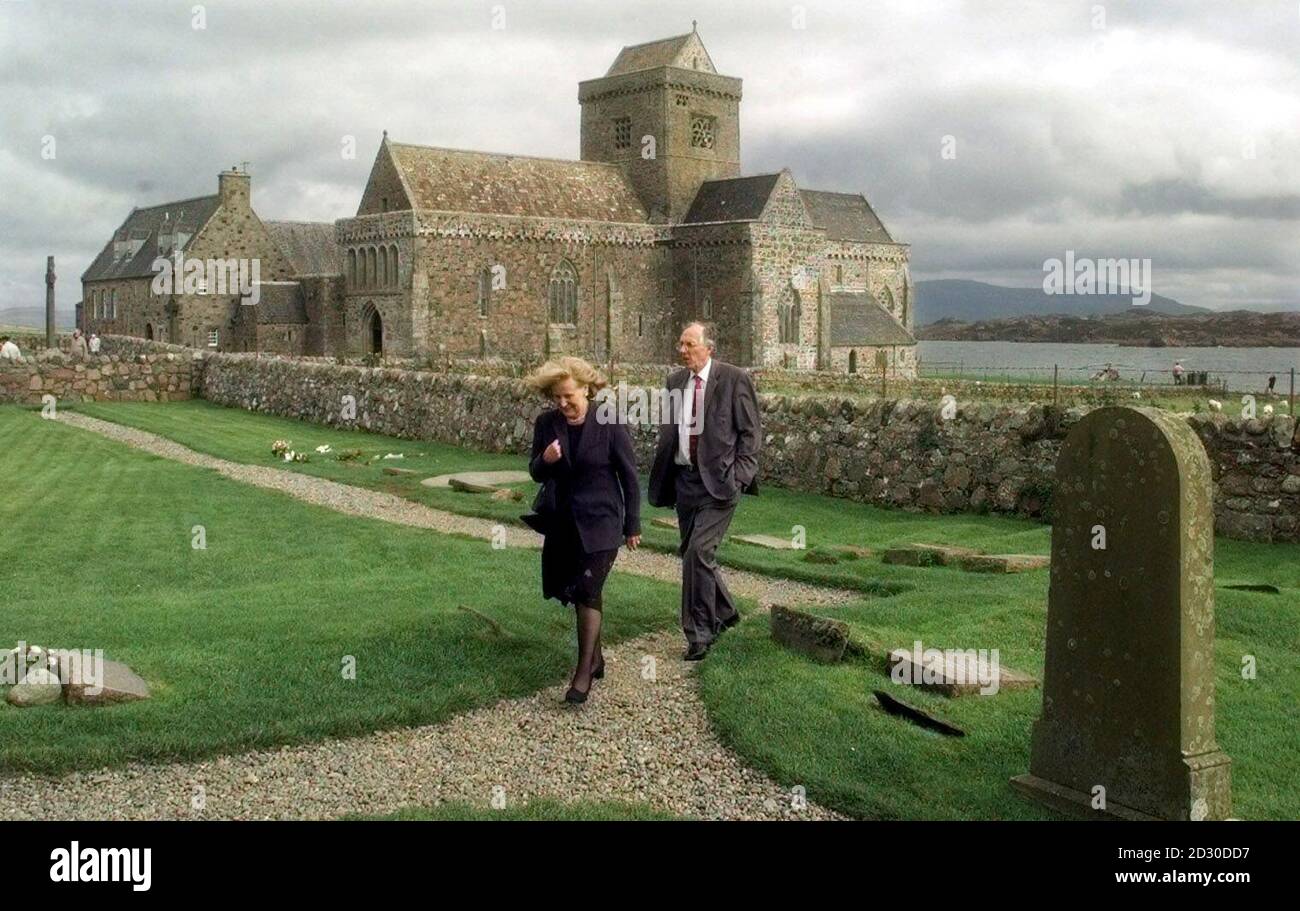 Scottish First Minister Donald Dewar accompanied by Baronness Elizabeth Smith, widow of former Labour leader John Smith, leave after visiting the grave of John Smith in the graveyard of the Abbey on the Isle of Iona off the west coast of Scotland.  *  Mr Dewar was on the island to announce that Historic Scotland will take over the running of the Abbey from the 100 year old Iona Cathedral Trust. Stock Photo