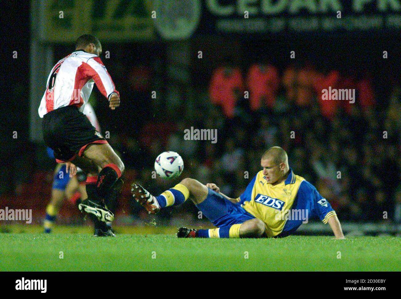 This picture may only be used within the context of an editorial feature. Southampton's Dean Richards (L) manages to stay upright as Derby County's Seth Johnson slides in for a tackle, during their FA Premiership football match at the Dell, Southampton. Stock Photo