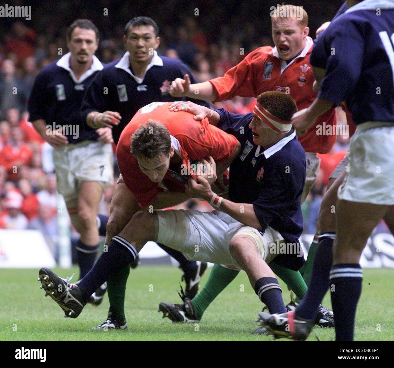 Wales ' Jason Jones-Hughes is hauled down yards from the line by  Japan 's Hiroyuki Tanuma  during the Rugby World Cup match at the Millennium Stadium in Cardiff.  Wales won the match 65-15.  Stock Photo