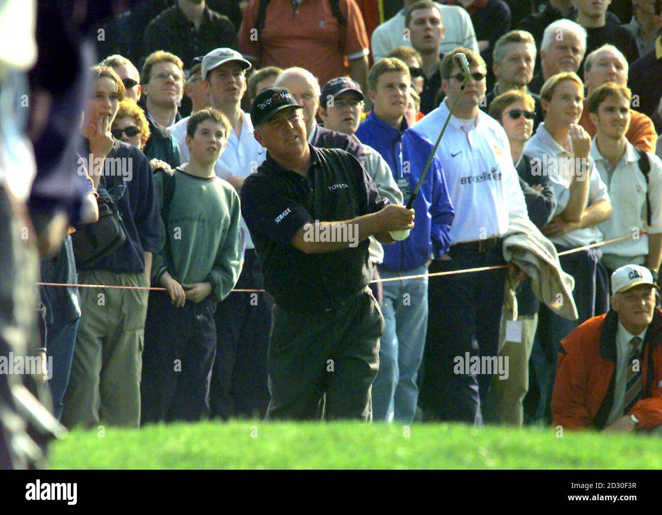 American Mark O'Meara on the 11th fairway watches his ball after shooting out of the rough while playing against Zimbabwean Nick Price, during the afternoon session of his semi final match in the Cisco World Match Play golf Championship at Wentworth. Stock Photo