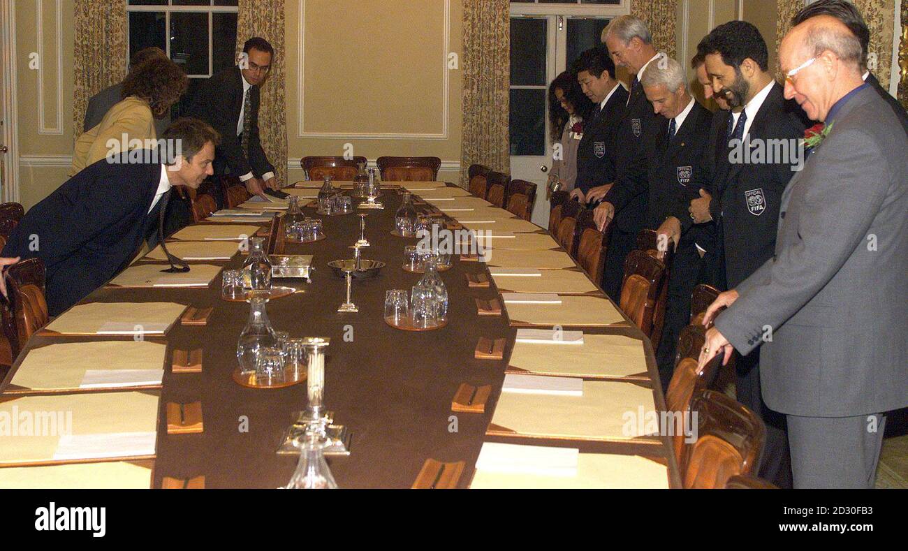 Prime Minister Tony Blair (L) appears to bow in front of the FIFA committee as they take their seats in Downing Street.  Britain is putting forward their bid to host the year 2006 soccer World Cup. Stock Photo