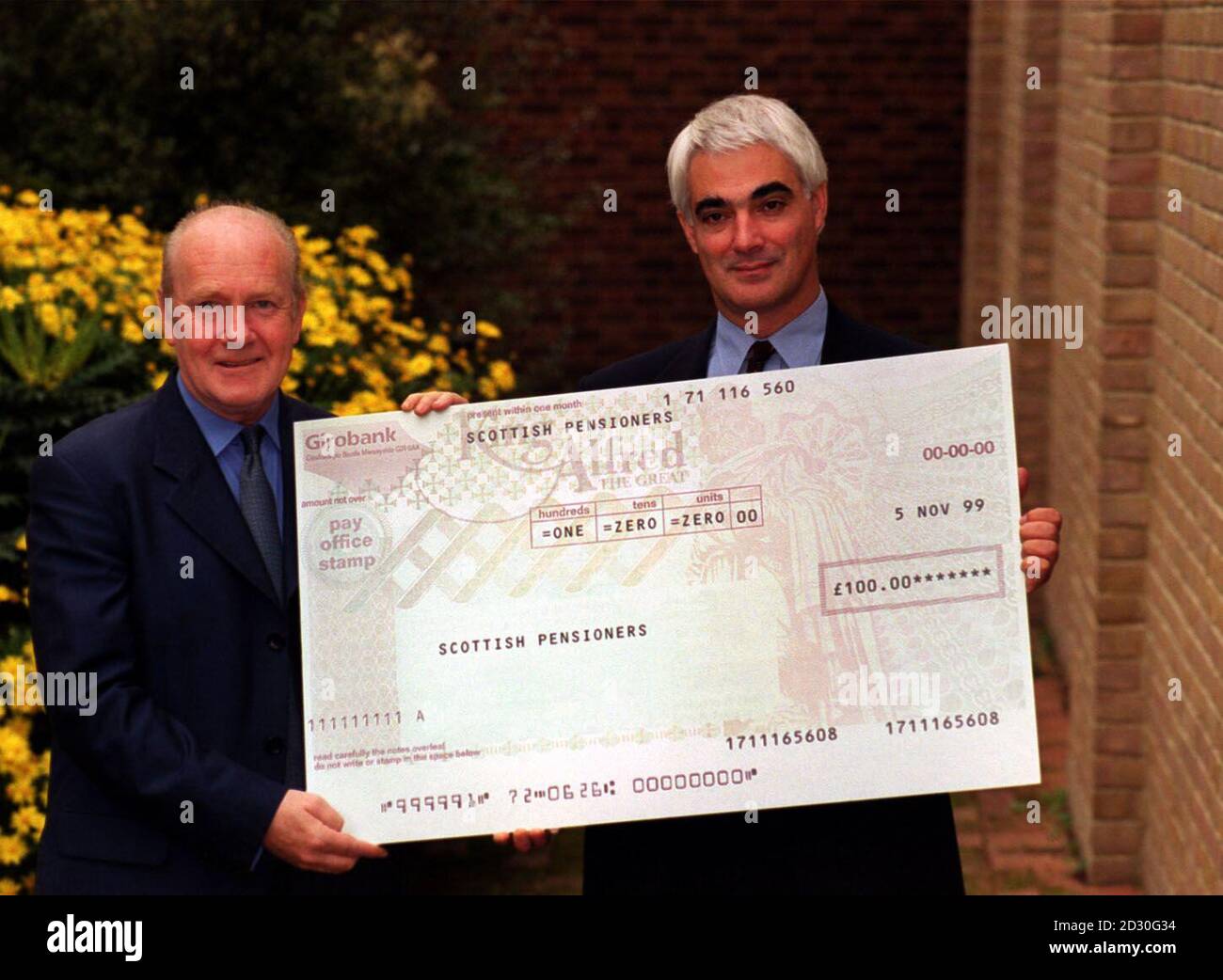 Secretary of State for Scotland John Reid (L) and Social Security Secretary Alistair Darling, in London, to announce that over 700,000 pensioners in Scotland would receive a cheque for  100 to help towards the cost of winter fuel bills.  Stock Photo