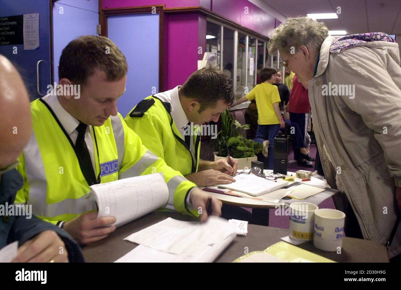 Police book in residents into the local sports centre in Paington, Devon as more than 400 people were evacuated from their homes, after a huge fire broke out at a nearby Wilton Bradley plastics factory.   *Devon and Cornwall police say the decision to evacuate part of the Kingsway estate, was taken after toxic fumes began to be given off by the fire. Stock Photo