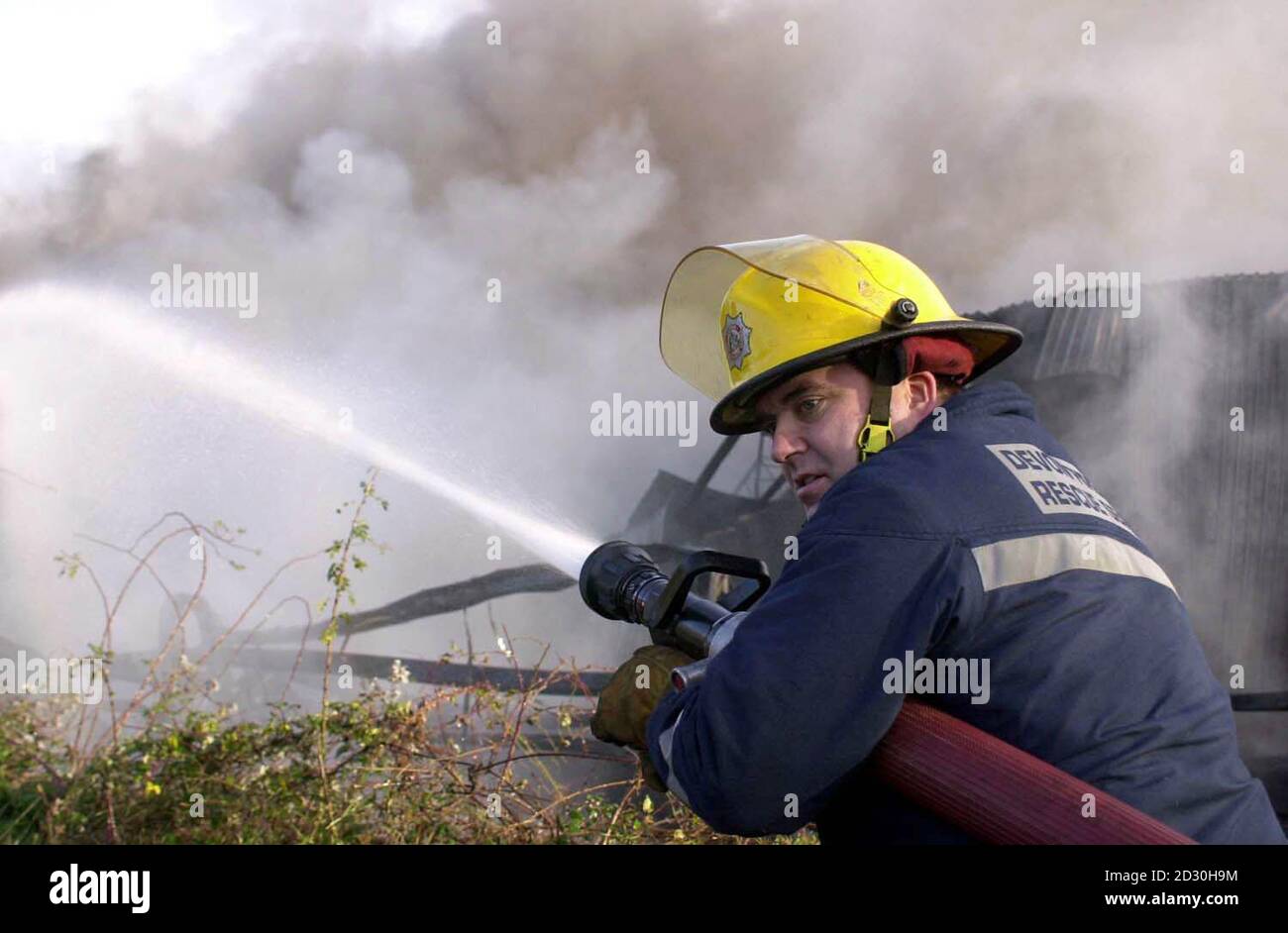 A firefighter takes the blaze at a plastic factory as more than 400 people were evacuated from their homes, after a huge blaze broke out at a nearby Wilton Bradley plastics factory.   *Devon and Cornwall police say the decision to evacuate part of the Kingsway estate, in Paignton, Devon, was taken after toxic fumes began to be given off by the fire. Stock Photo