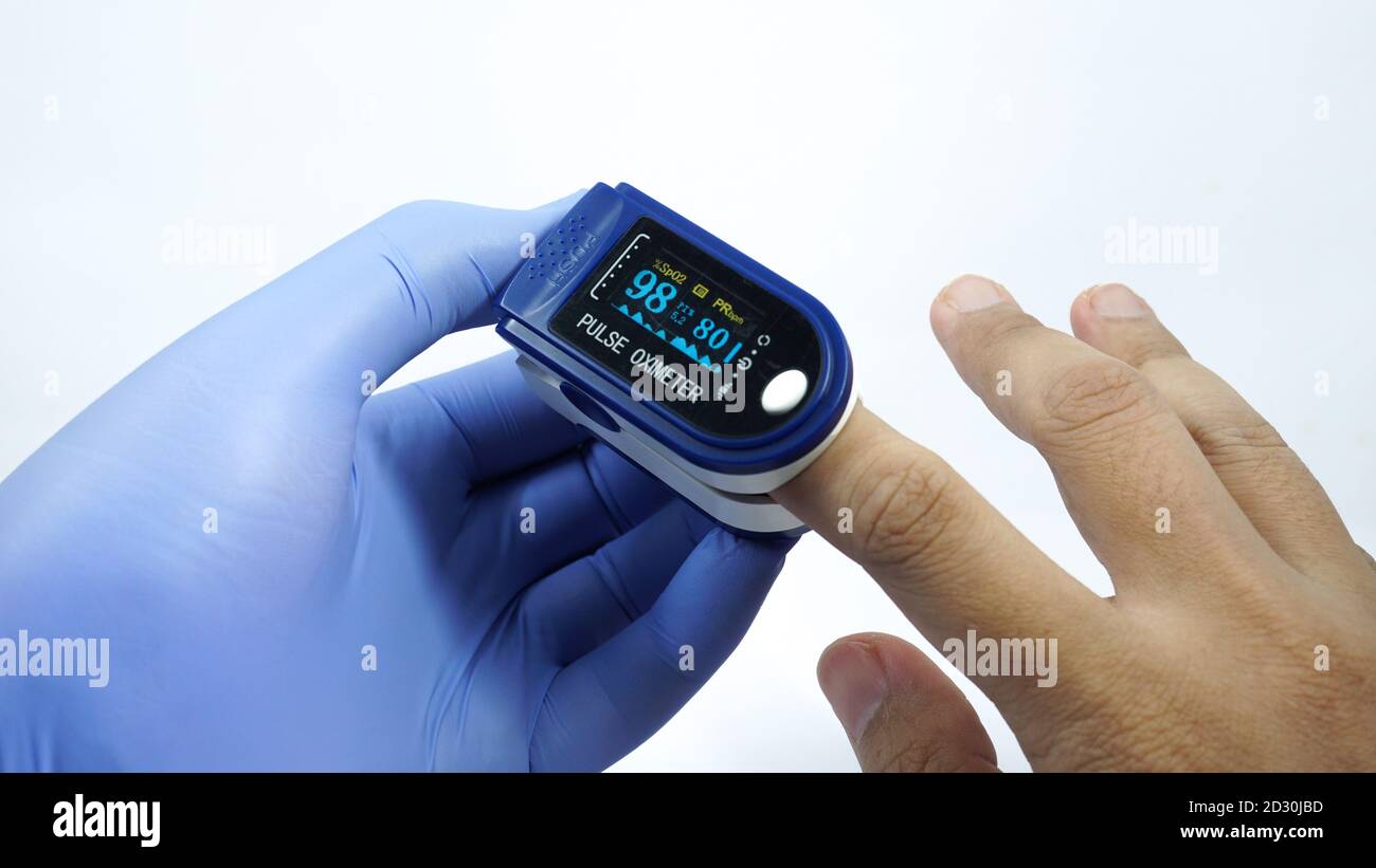 Pulse oximeter used to measure pulse rate and oxygen levels Stock Photo