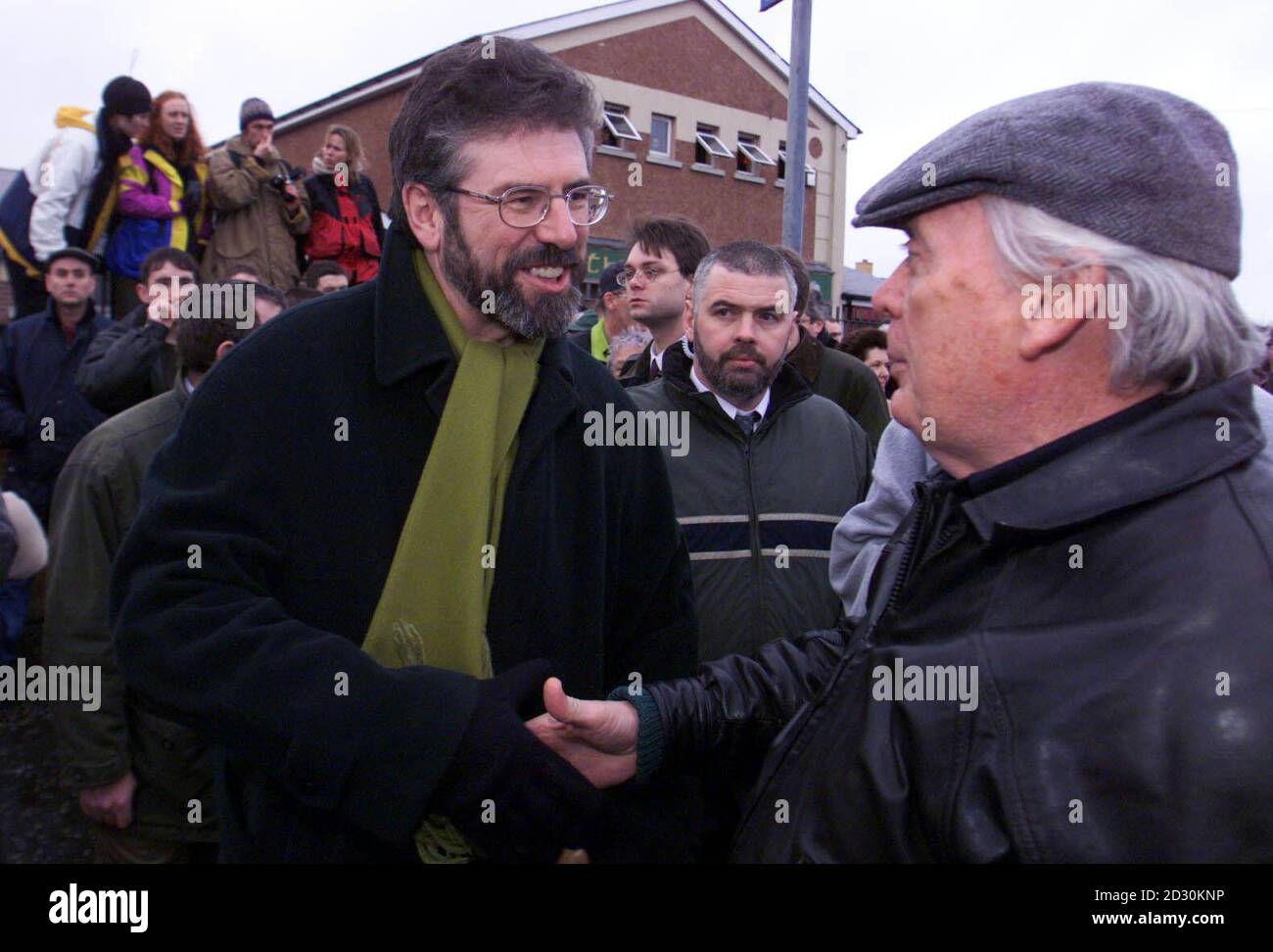 Sinn Fein President Gerry Adams (L) is welcomed to the Bloody Sunday rally in Londonderry, in memory of the 14 people who were shot dead by British paratroopers in the city in 1972. Stock Photo