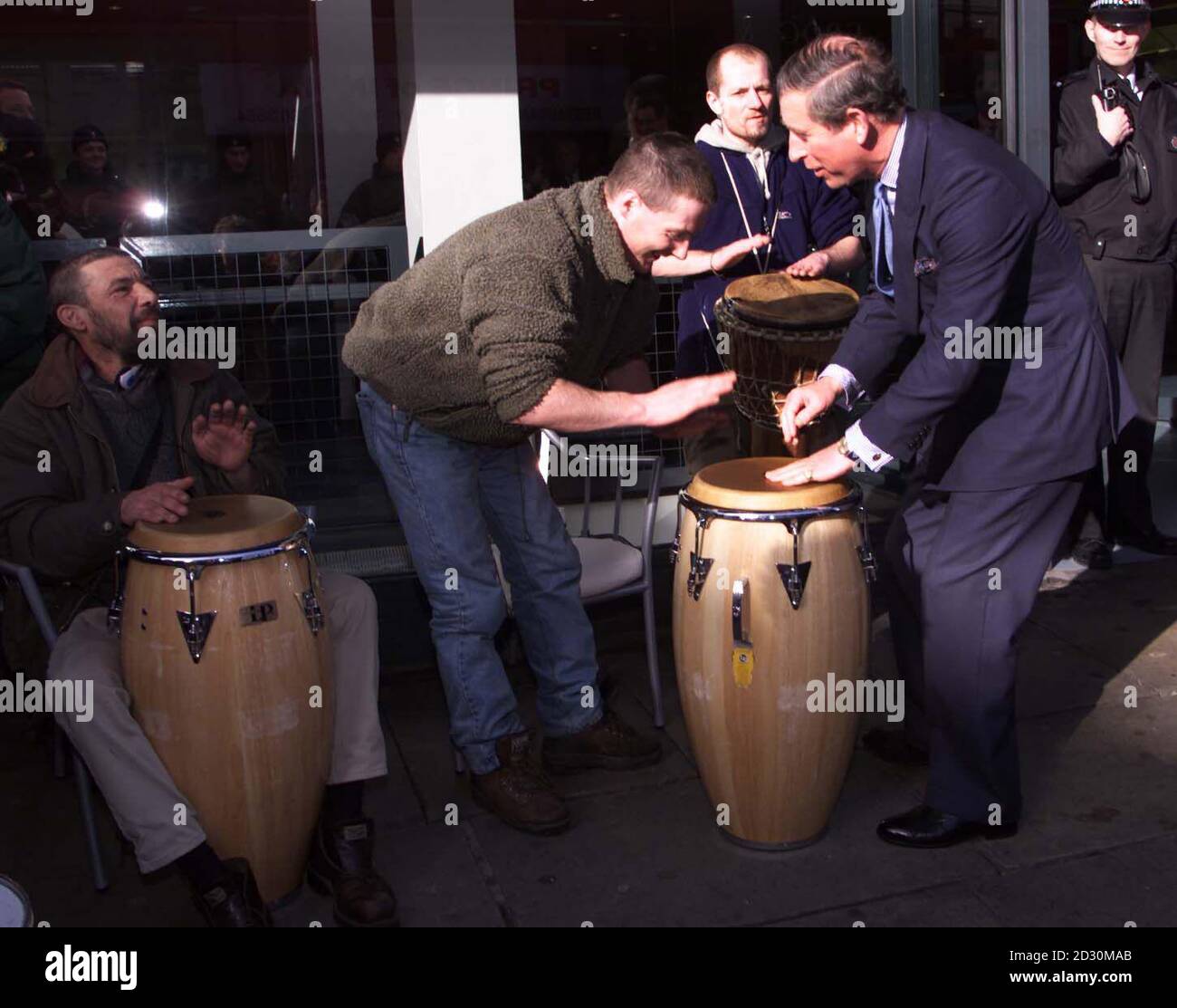 The Prince of Wales (R) attempts a tune with Big Issue seller Mike Martin on the drums during a visit to Ancoats in Manchester as part of a tour of regeneration projects in the North. * He was joined by the Crown Prince of Spain, Prince Felipe, The Prince of Asturias, who flew to Britain on a Guest of Government visit. Stock Photo