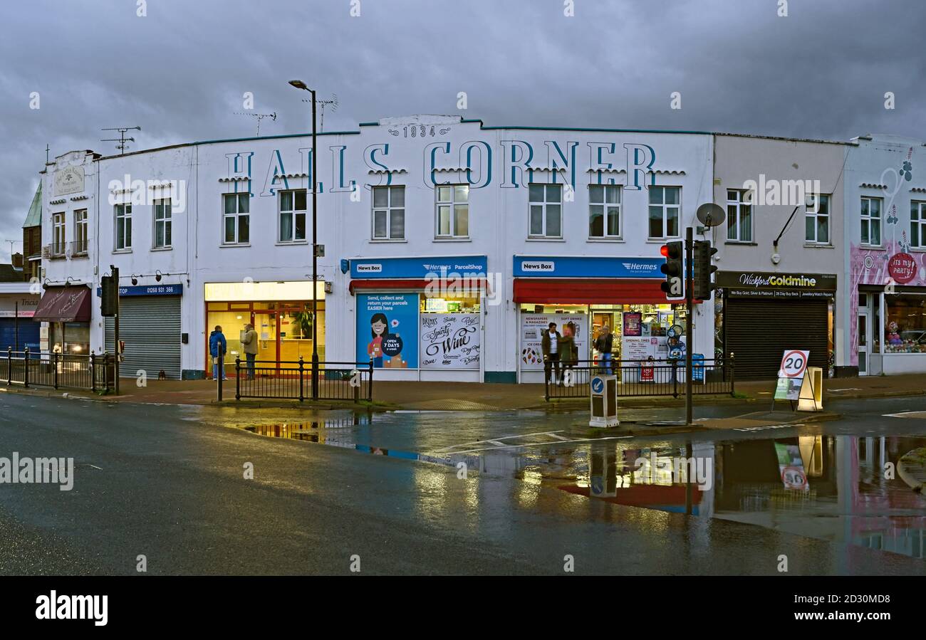 Shops at Halls Corner where London Road meets the High Street at Wickford, Essex. UK.  Flooding opposite after heavy rain. Stock Photo