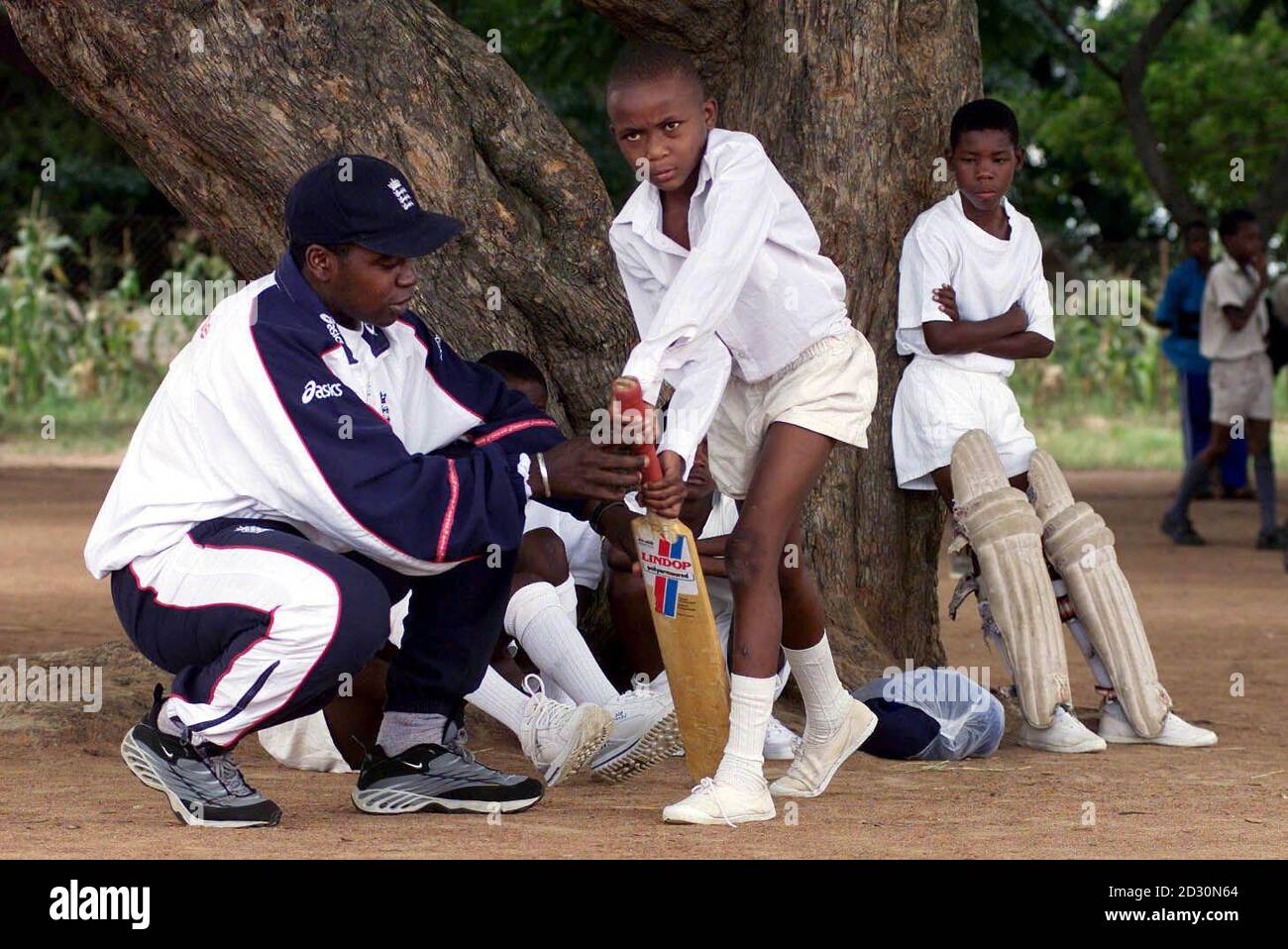 England cricketer Mark Alleyne coaches children from the Chipembere School in Highfield near Harare. Alleyne is a member of the one day cricket squad touring Zimbabwe. Stock Photo