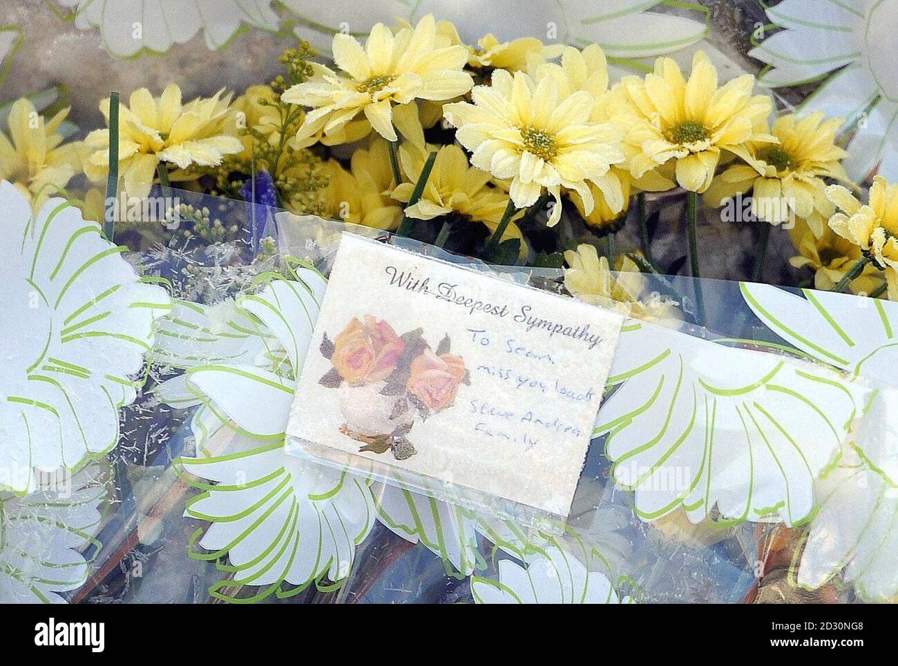 Floral tributes at the scene outside an address on Woodgate Road in the Mile End area of Coleford in the Forest of Dean, where a man was fatally stabbed in the early hours of yesterday morning. Stock Photo