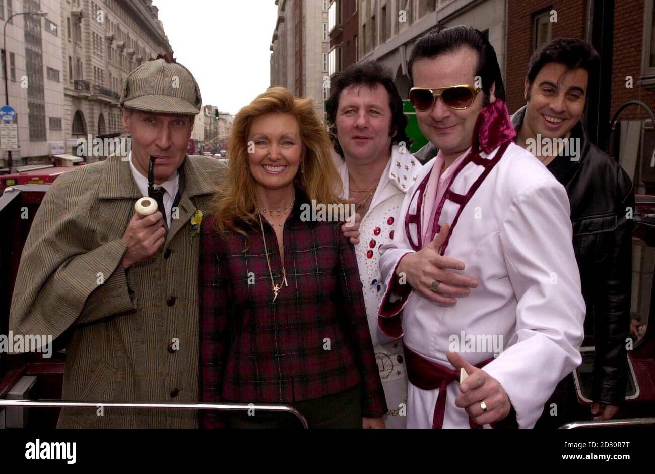 A Sherlock Holmes lookalike, Elvis Presley's cousin Donna Presley Early and Elvis tribute acts Bobby Memphis, Kenny Dee and Mario, at Baker Street, London, where auditions are being held for Elvis and Beatles lookalikes to launch Karaoke sightseeing bus trips. Stock Photo