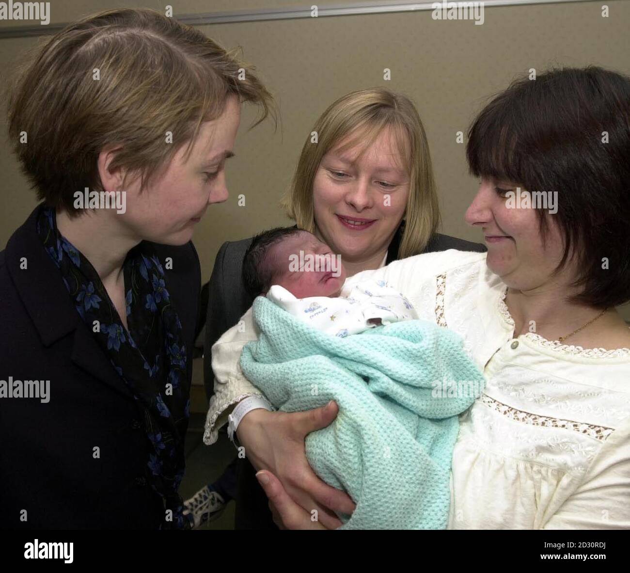 Social Security Minister Angela Eagle (c) with Public Health Minister Yvette Cooper (l) and new mum Lauratina Reddy from London with baby Ankieat at Guy's Hospital in London,  where they announced that the Sure Start maternity grant is to be doubled.   *More than 200,000 new or expectant mothers in the UK are eligible for the  200 cash, designed to help them buy essential goods for their babies.  Stock Photo