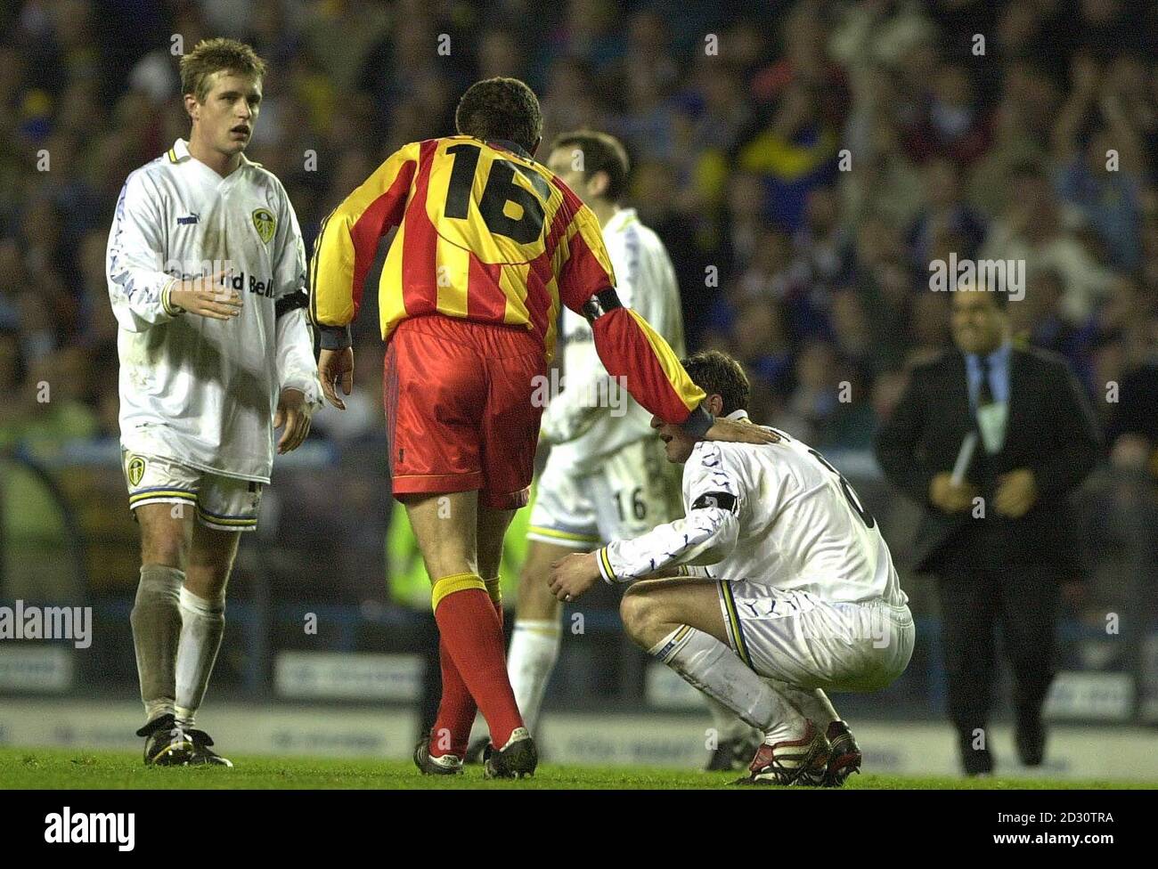 This picture can only be used within the context of an editorial feature.  A consolation pat from Ahmet Yildirim of Galatasaray for Leeds United player Michael Bridges after Leeds were knocked out of the UEFA Cup football match. Stock Photo