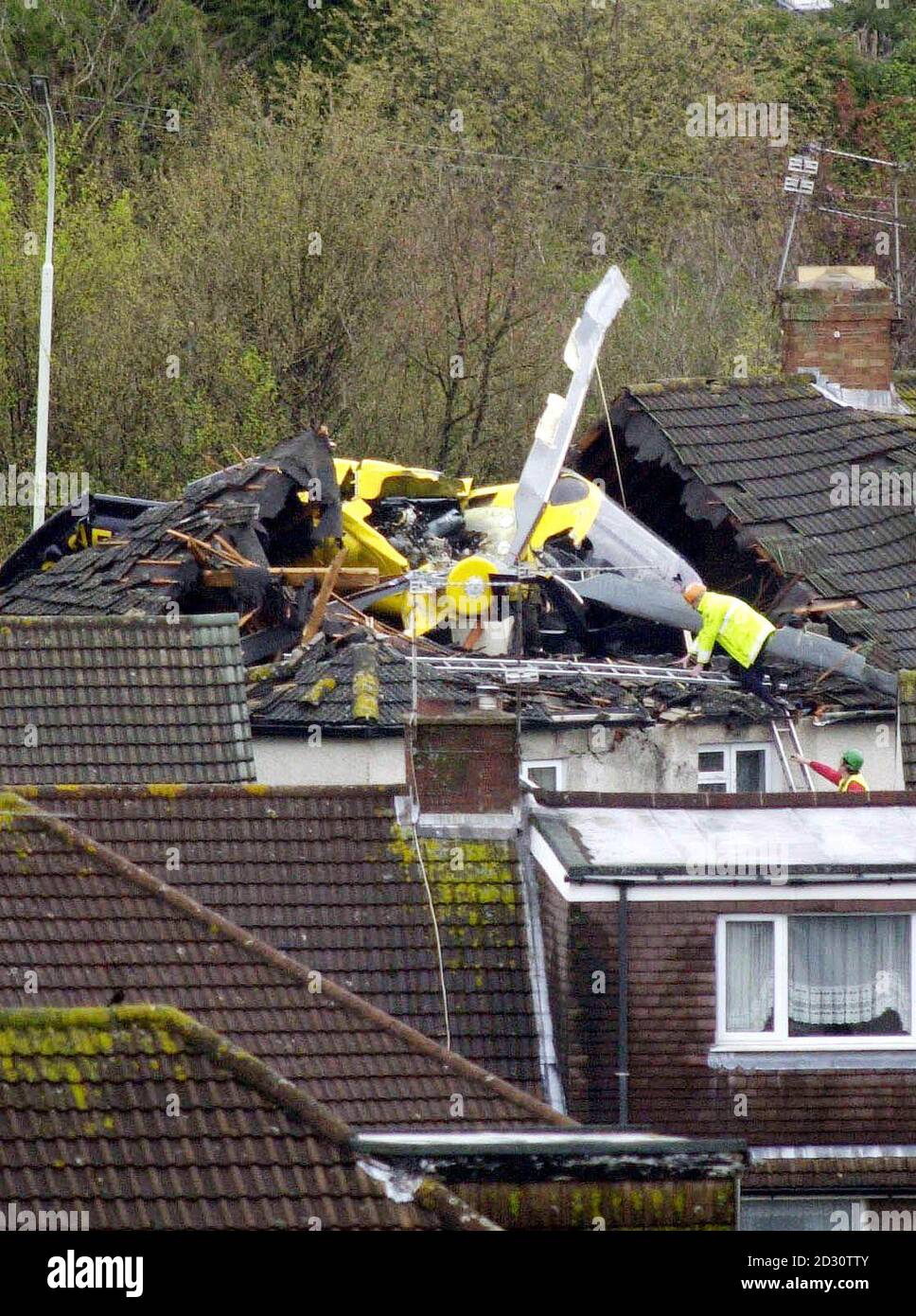 The wreckage of a police helicopter on the roof of a house after the