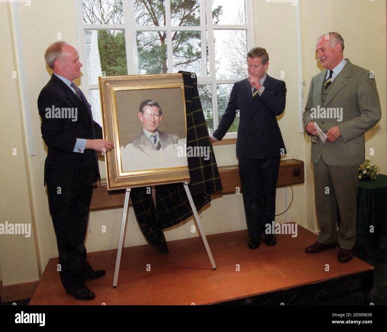 Artist Richard Stone (l) with the Prince of Wales unveils a new portrait of the Prince as General Sir Peter Graham (r) looks on, at the Gordon Highlanders Museum, Aberdeen. Stock Photo