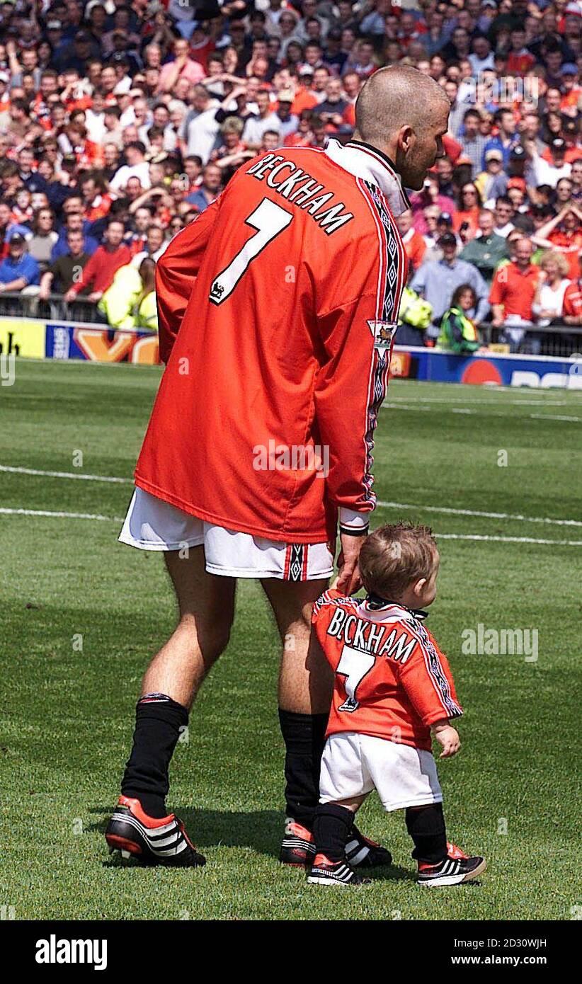 This picture can only be used in the context of an editorial feature. Manchester United's David Beckham walks around the pitch with his son Brooklyn, as his side were crowned FA Carling Premiership Champions after the game against Tottenham Hotspur.  * ...at Old Trafford, Manchester. Final score : Manchester United 3, Tottenham Hotspur 1. Stock Photo