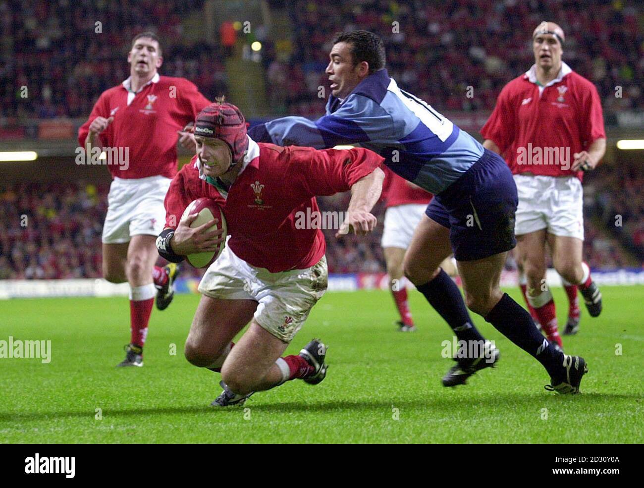 Wales' Ian Gough scores a try despite the attentions of French Barbarian Filipo Toala, during their Rugby match at the Millennium Stadium, Cardiff. Stock Photo