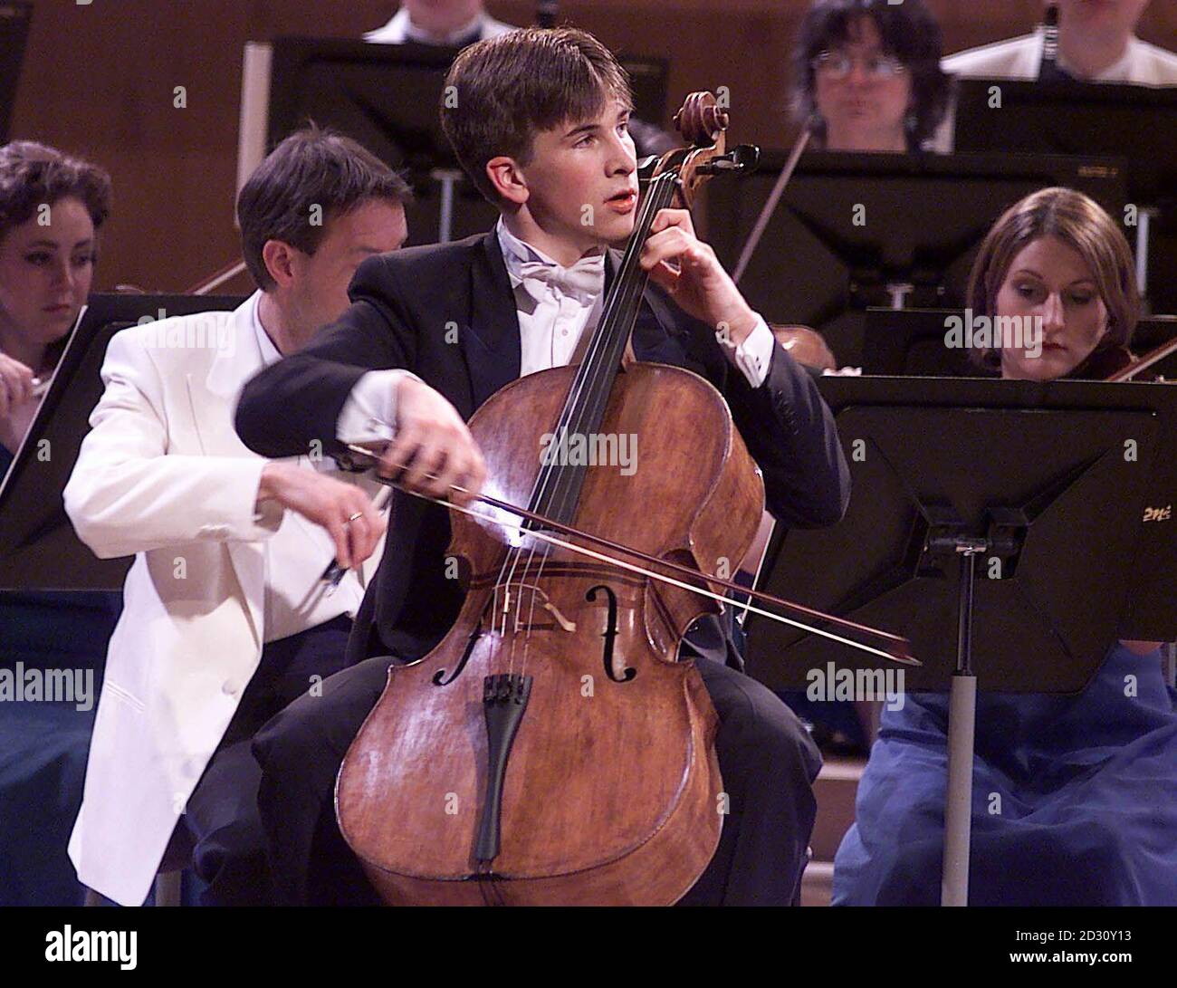 18 year old Guy Johnston plays his Cello on the way to winning the BBC Young Musician of the Year 2000 competition, at the Bridgewater Hall in Manchester. One of Guy's strings broke at the start of his performance but he managed to keep his composure. * ...changing the string and carrying on to win. Stock Photo