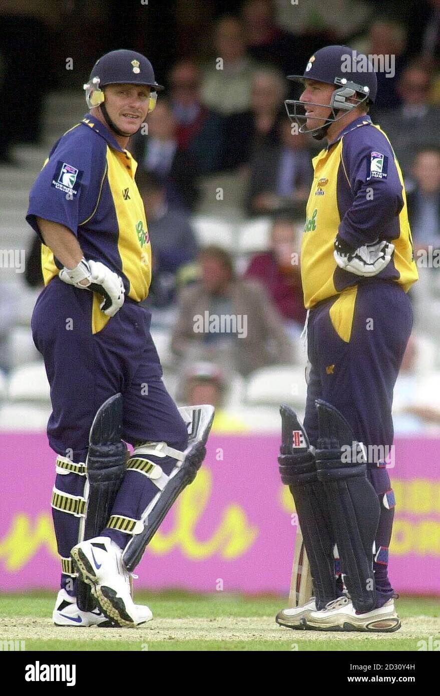 Hampshire's Shane Warne from Australia (R) with captain Robin Smith take a break from the Surrey bowling, during their National League Division Two match at the Oval. * Warne scored 34 and Hampshire's Shane Warne from Australia (R) with captain Robin Smith take a break from the Surrey bowling, during their National League Division Two match at the Oval. * Warne scored 34 and